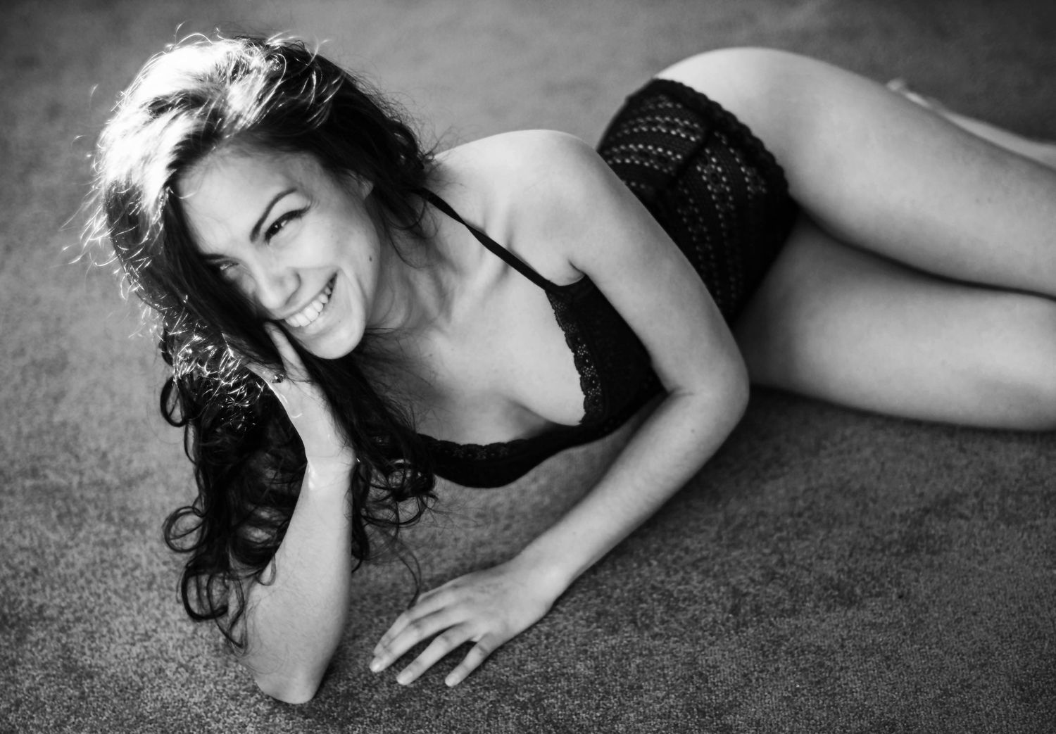 Black and white artistic boudoir photos showing artistic poses against dark background.
