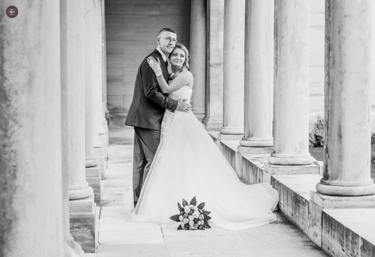 Elegant white columns frame a romantic scene at a historic venue.