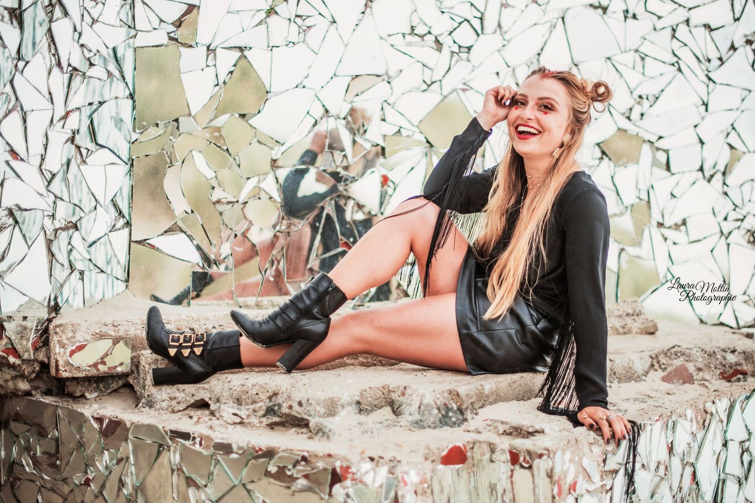 Fashion model poses in casual attire against a white floral backdrop.