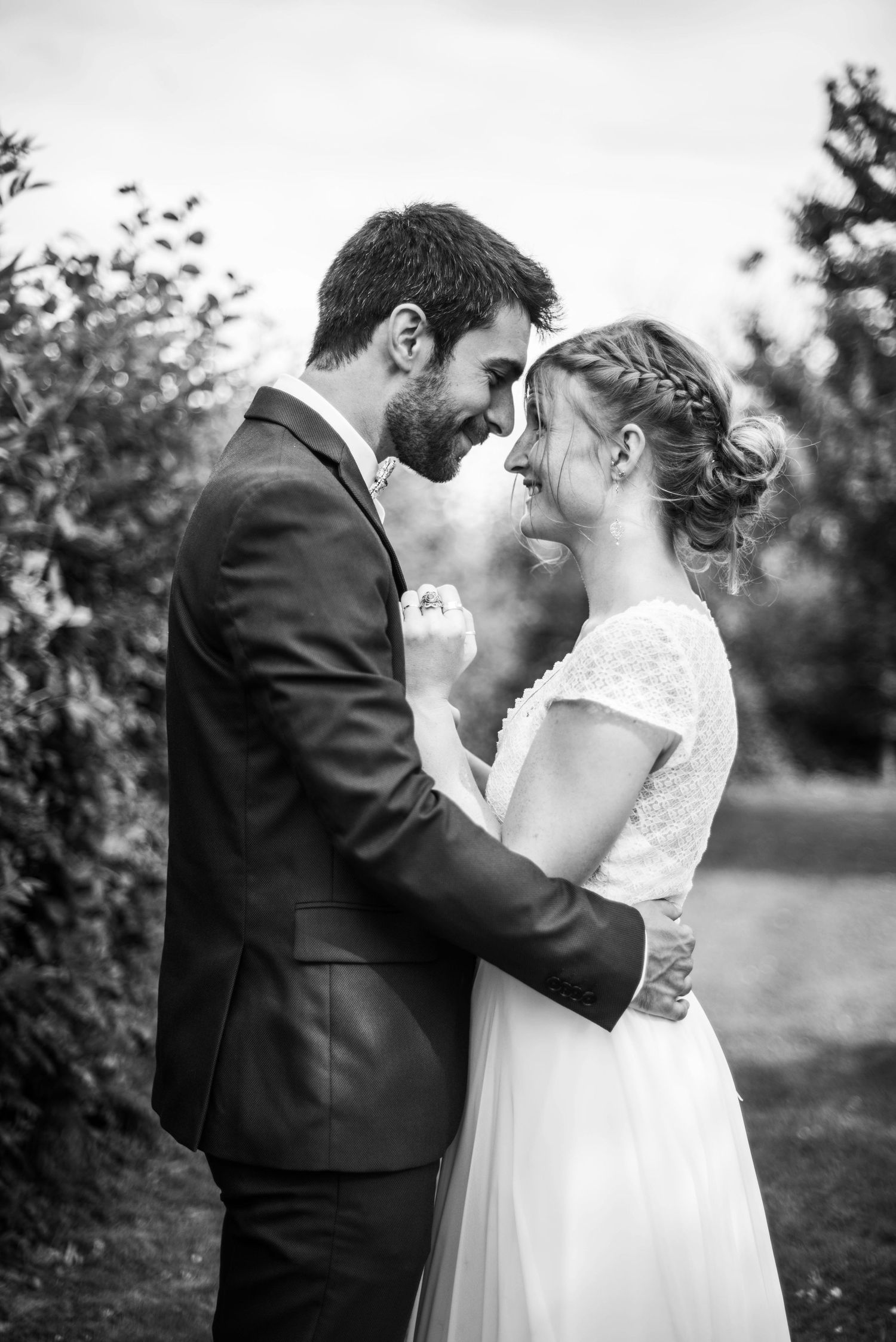 A romantic black and white wedding portrait series showing tender moments between newlyweds.