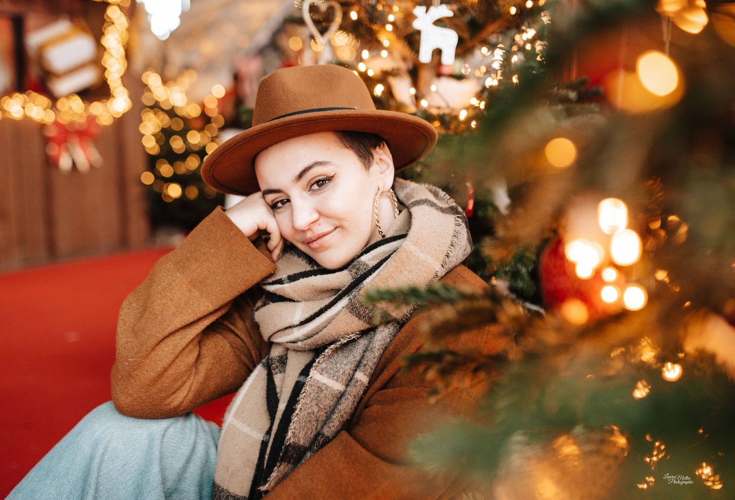 Winter fashion shots with tan hat and plaid scarf against festive Christmas decorations.
