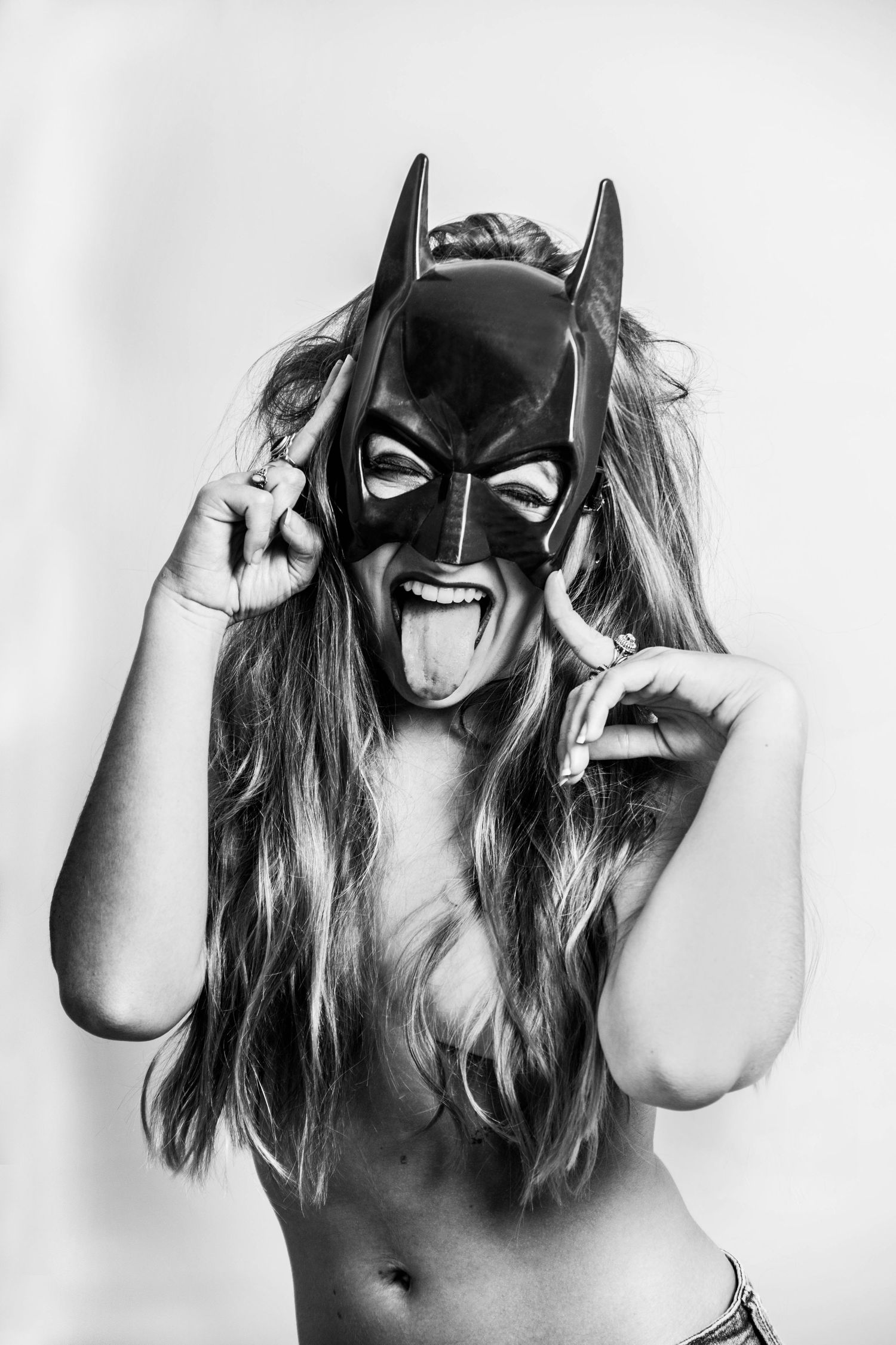 Black and white artistic portrait series featuring a figure wearing a Batman mask in dramatic poses.