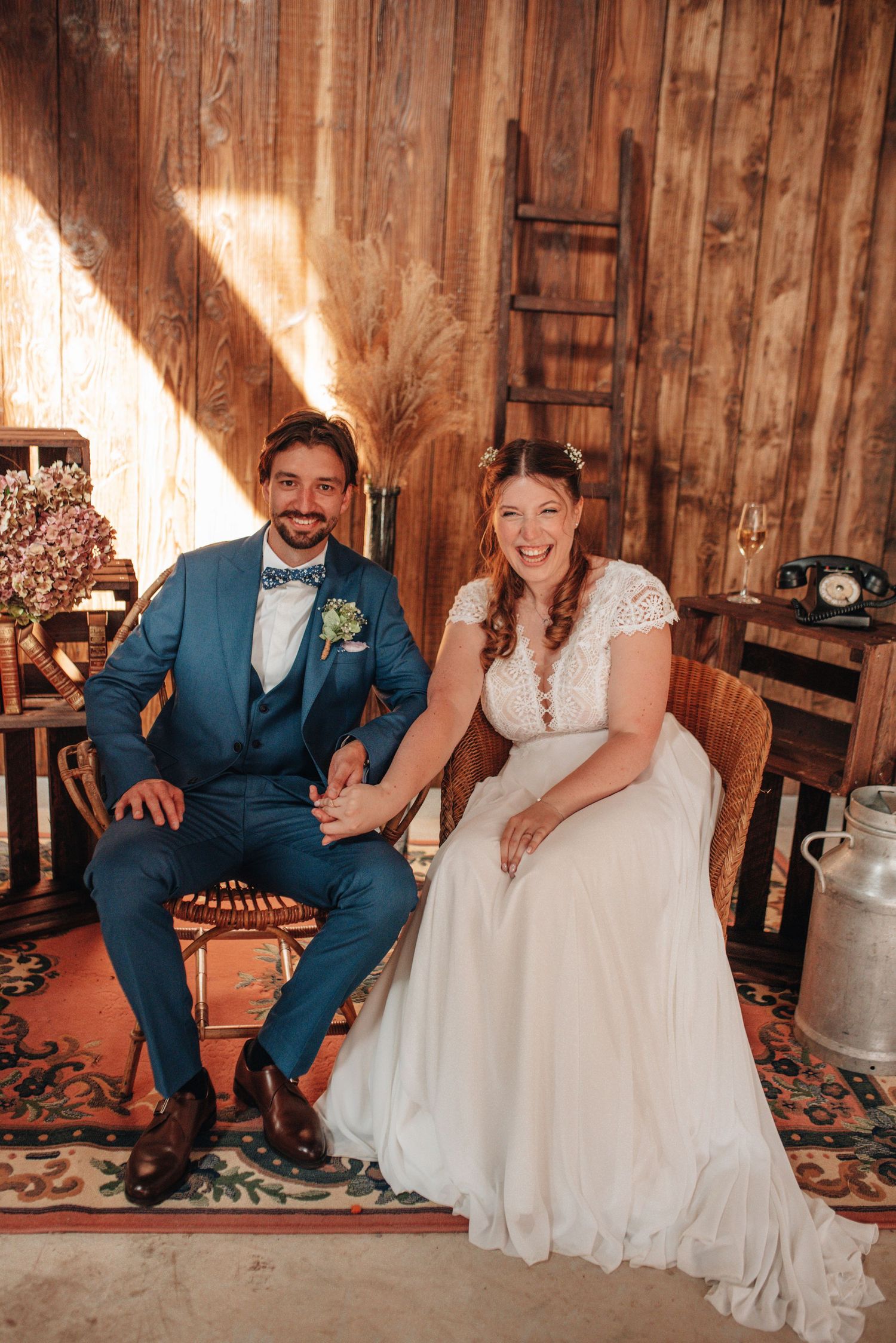 Candid moments of newlyweds laughing together in rustic wooden barn setting.