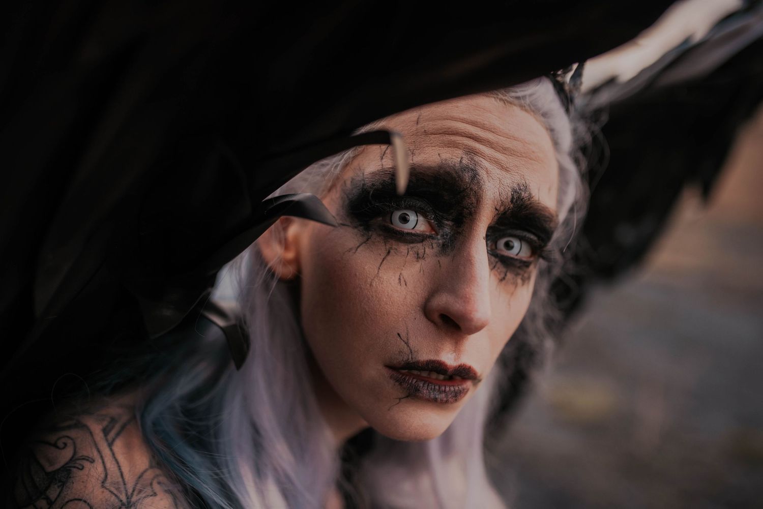 A gothic styled close-up portrait with dramatic makeup and lighting.
