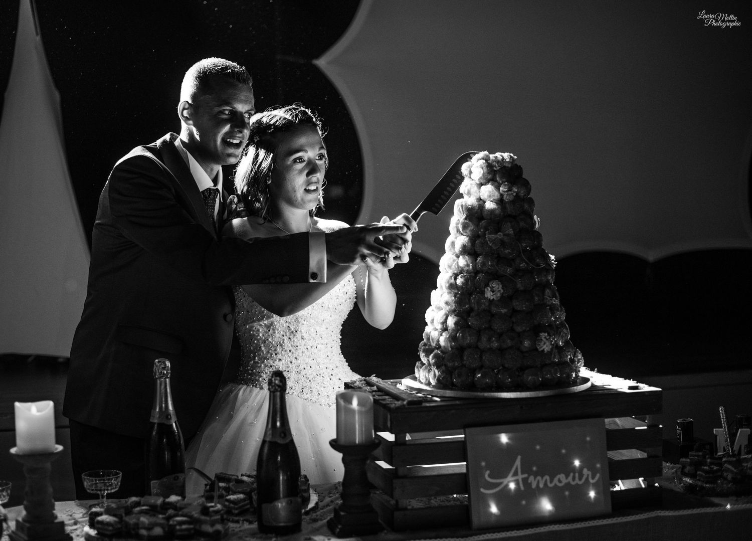 Wedding cake display with sparklers creating a dramatic black and white scene.