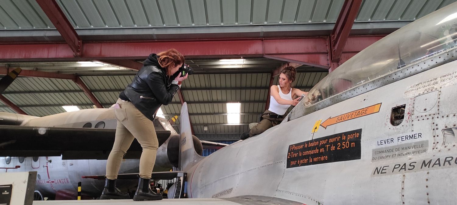 Two photographers taking creative angles while shooting on large aircraft.