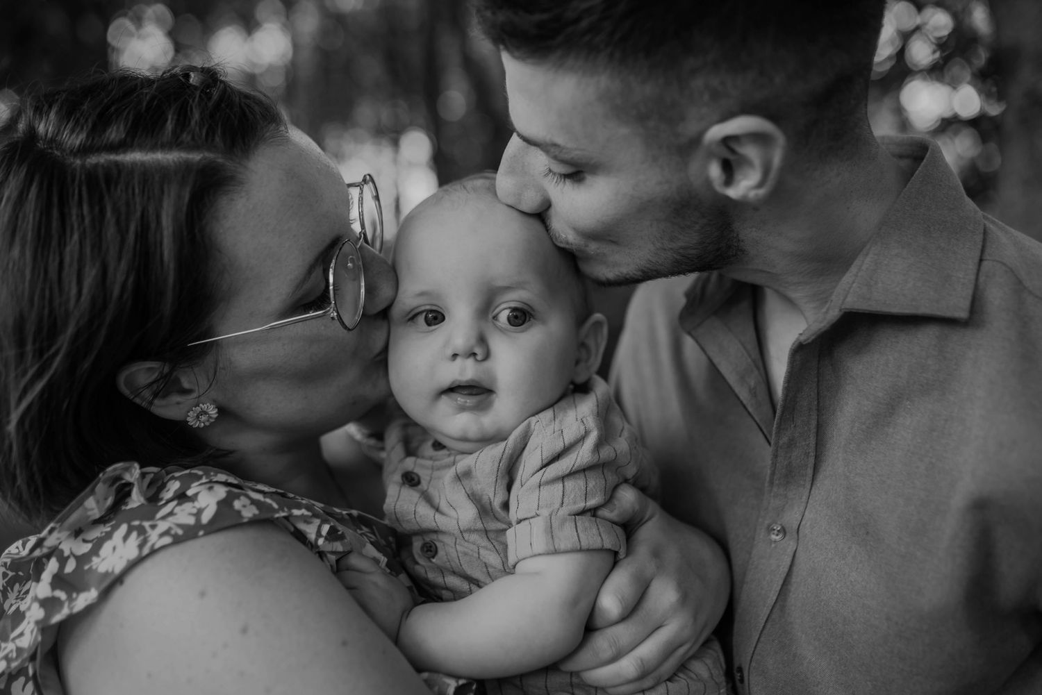 Black and white series capturing sweet family moments with a baby and parents.
