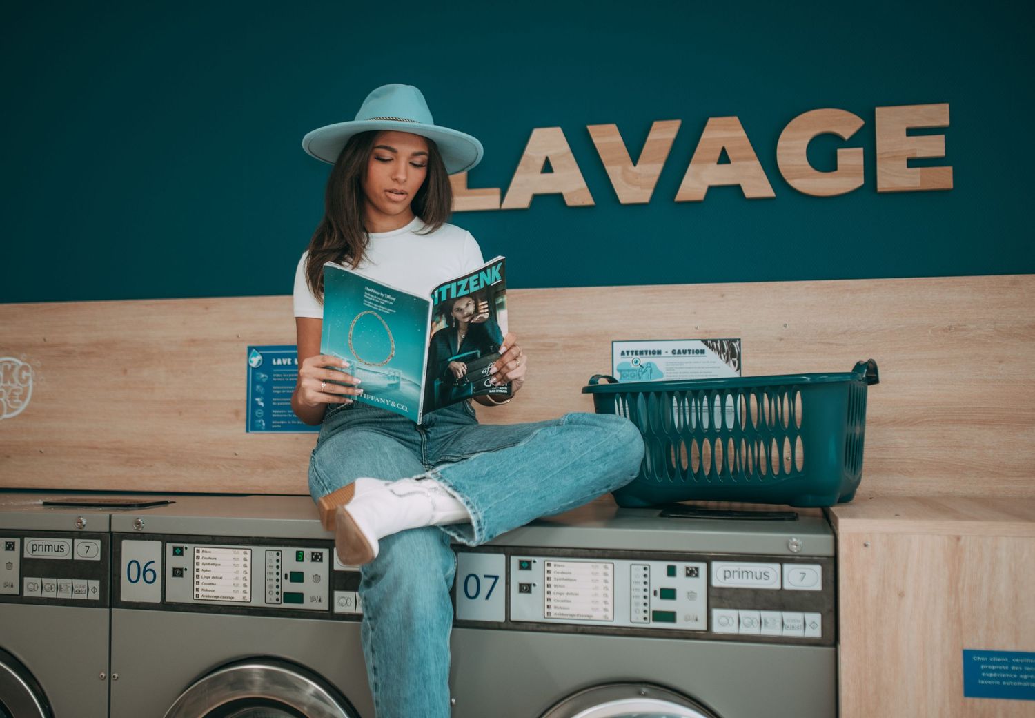 Lifestyle photography at a laundromat with vintage-style signage and machines.