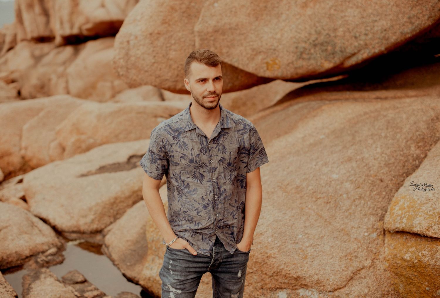 Portrait session on rocky terrain with warm sunset lighting.