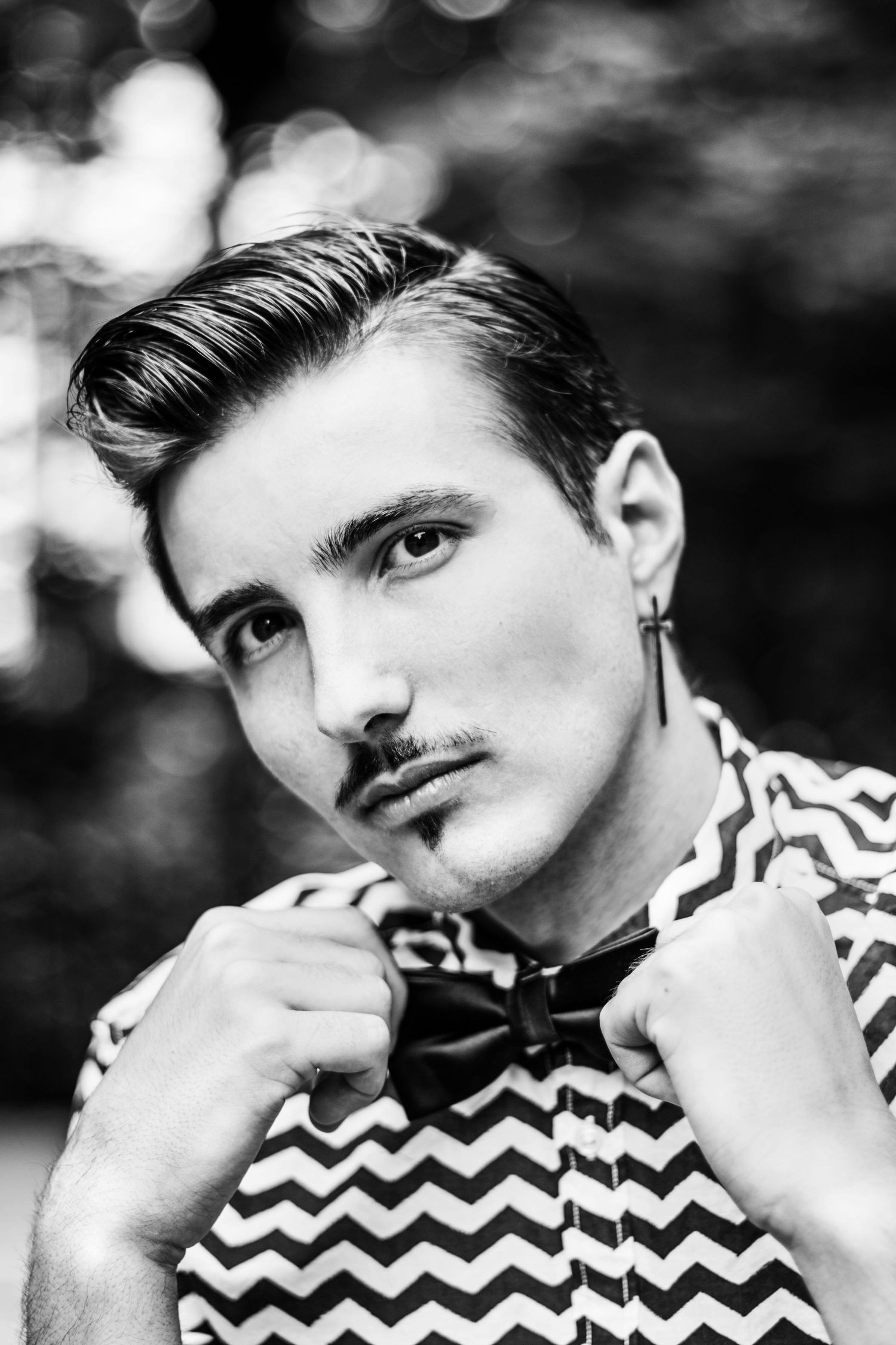 Black and white portrait with chevron pattern shirt.