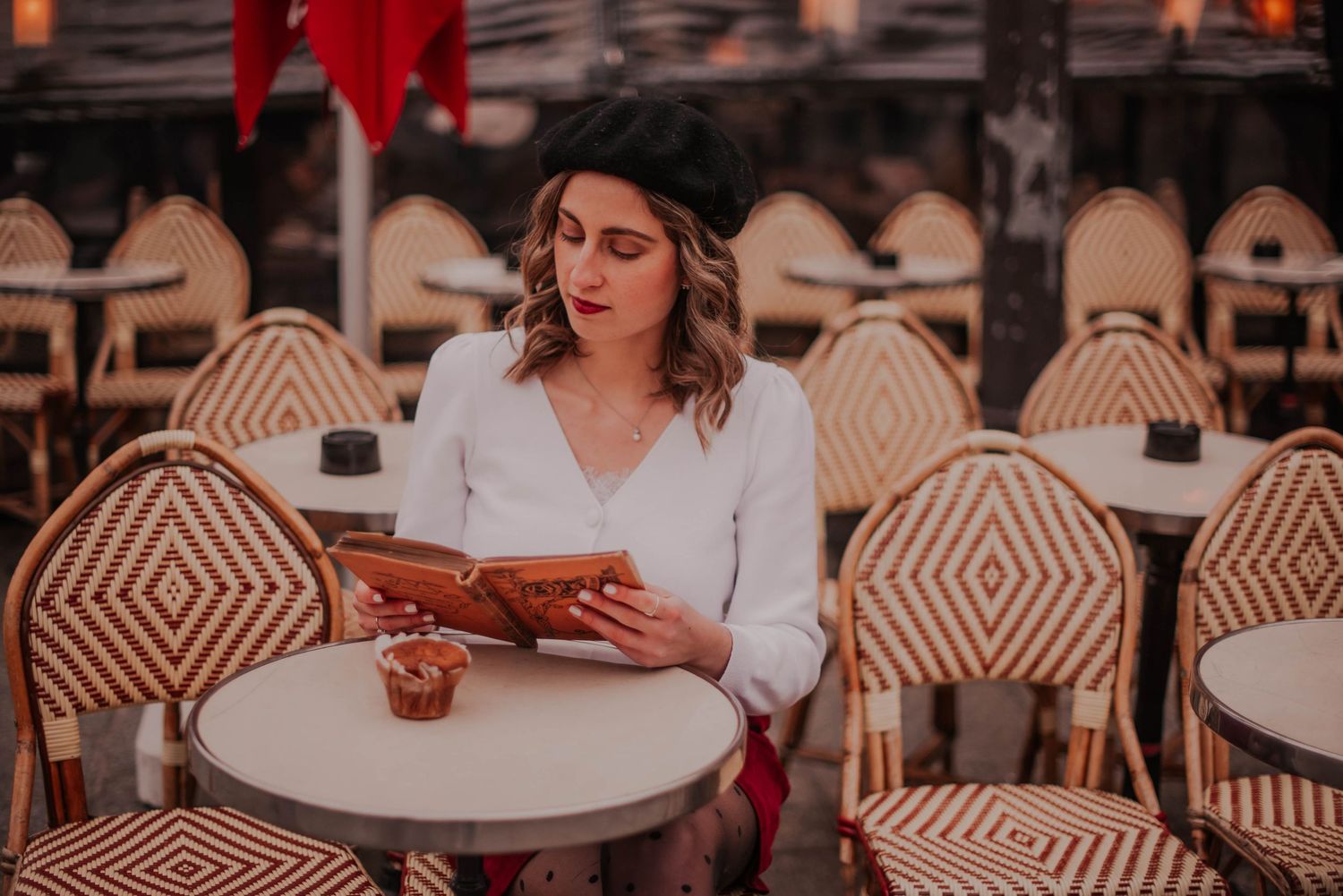 Parisian cafe scene with geometric patterned chairs and outdoor seating.