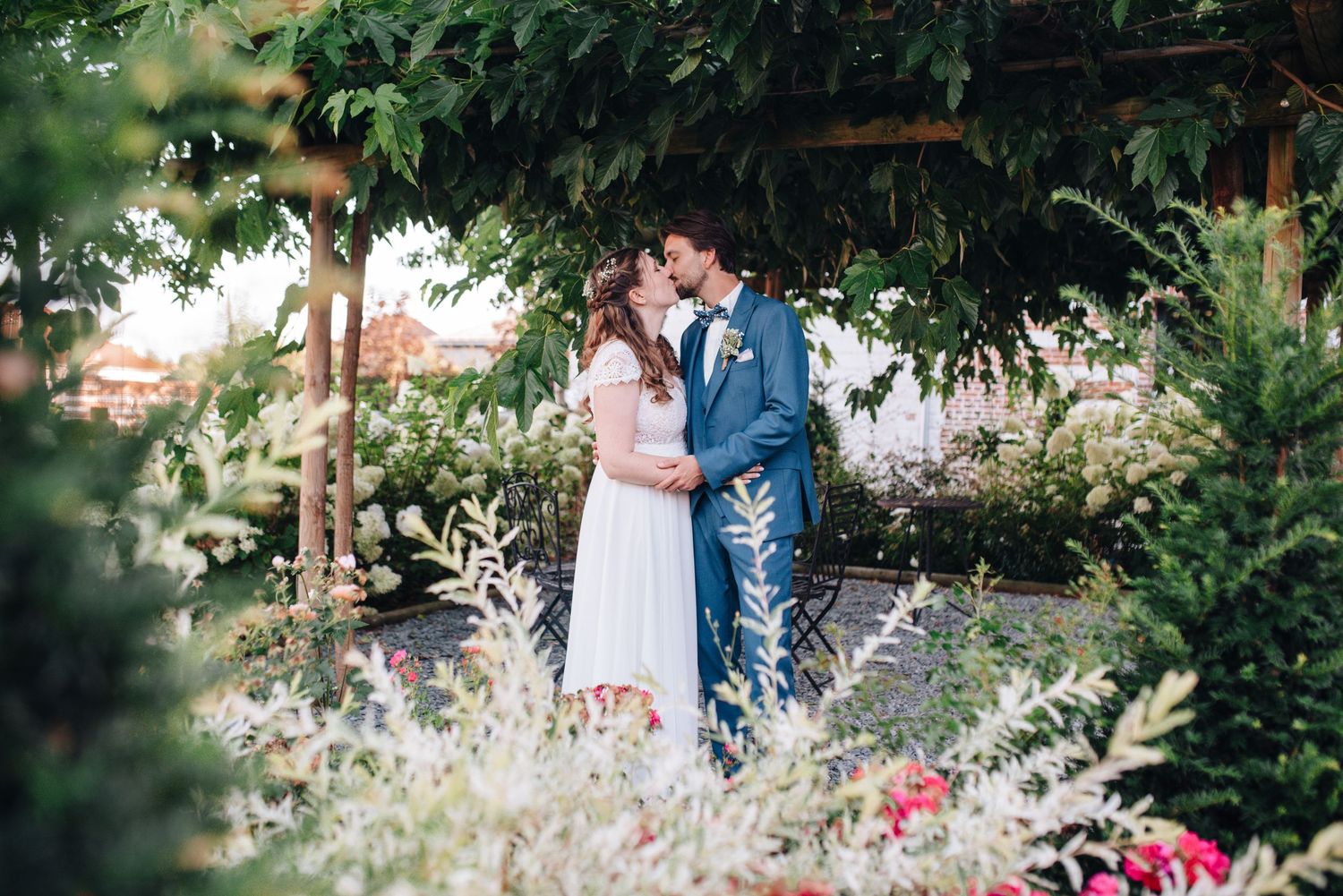 Garden wedding venue with lush greenery and blooming flowers creating a romantic backdrop.