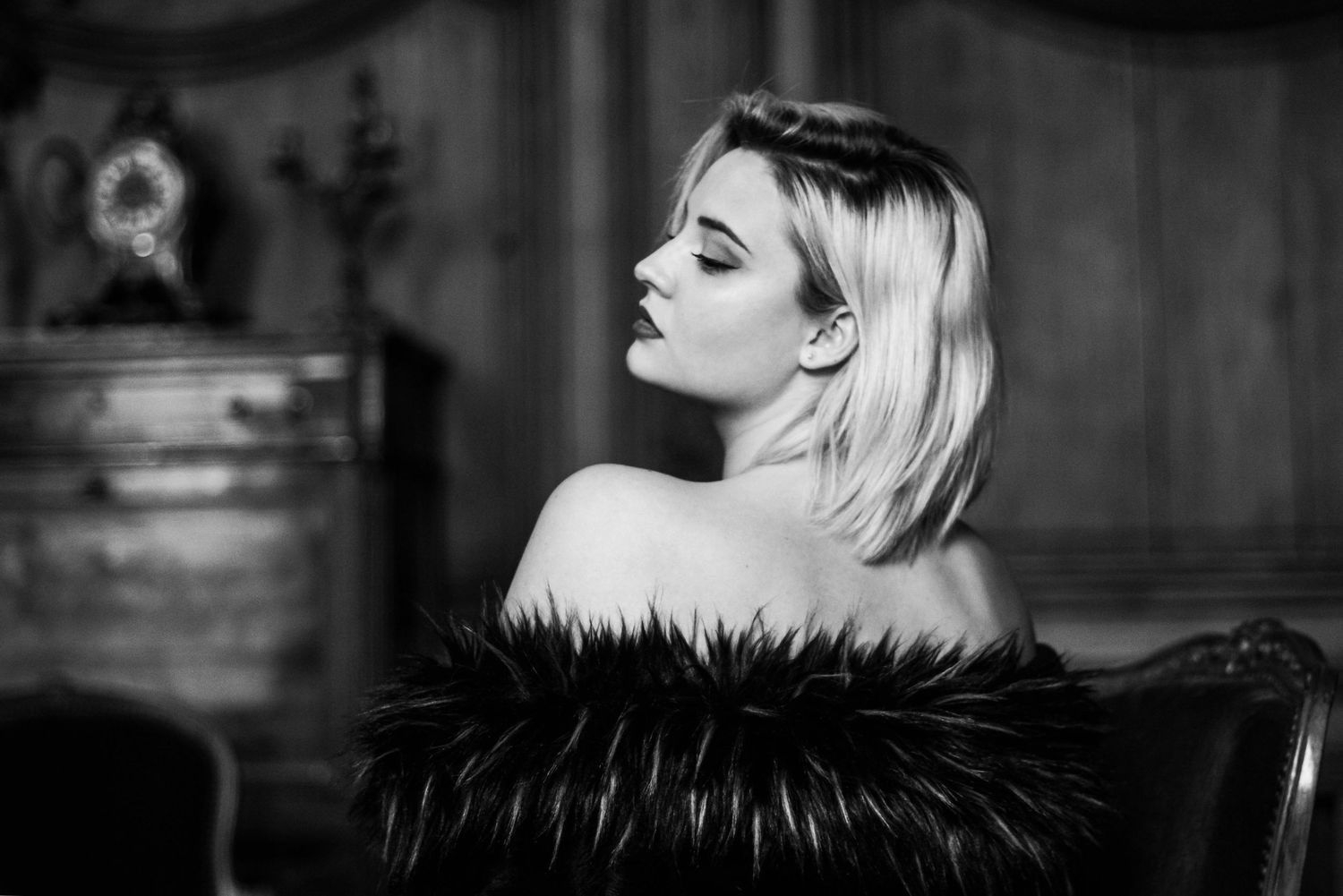 A black and white collage of fashion portraits showing dramatic lighting and artistic poses.