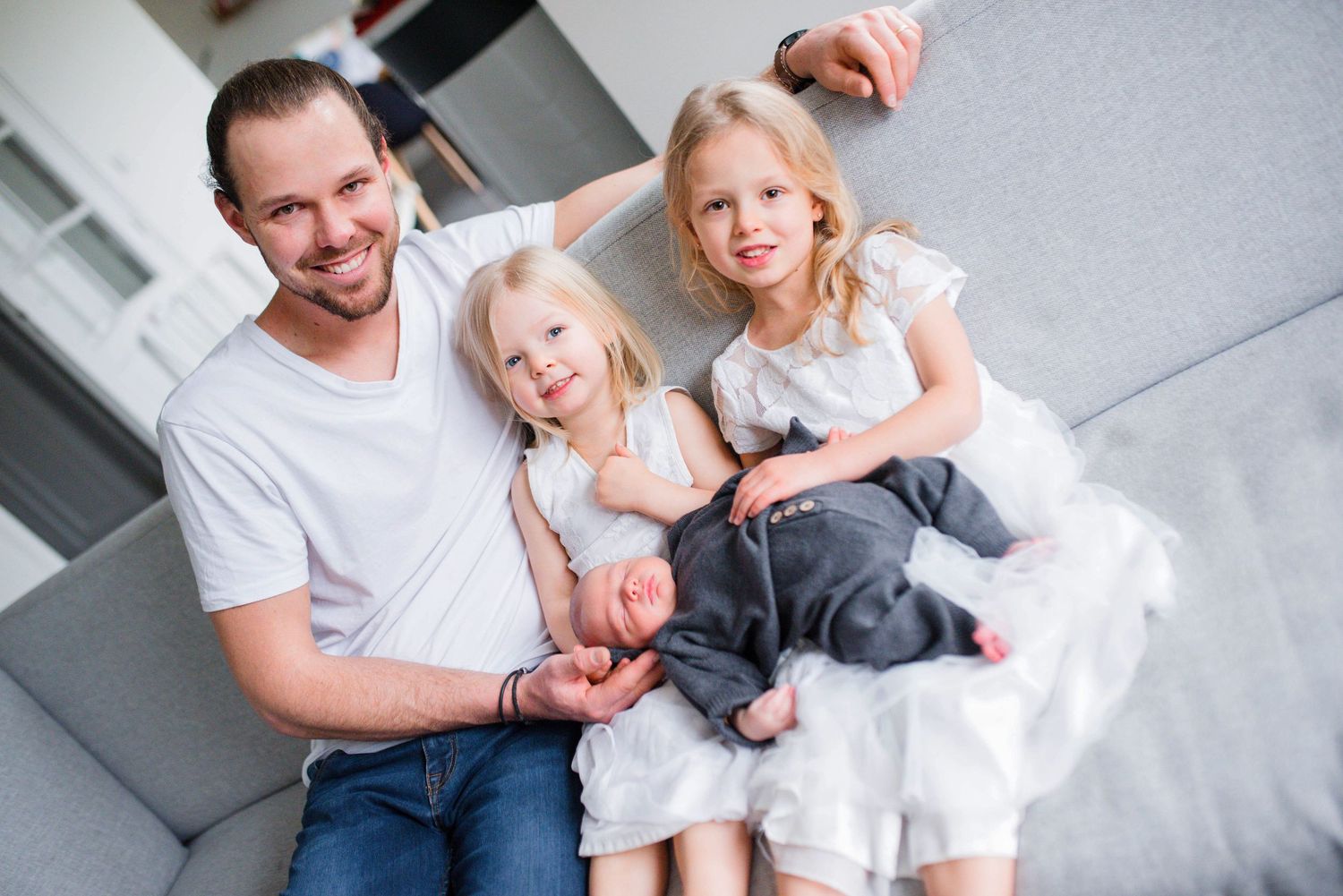 Candid family photos showing playful interactions on light colored bedding.