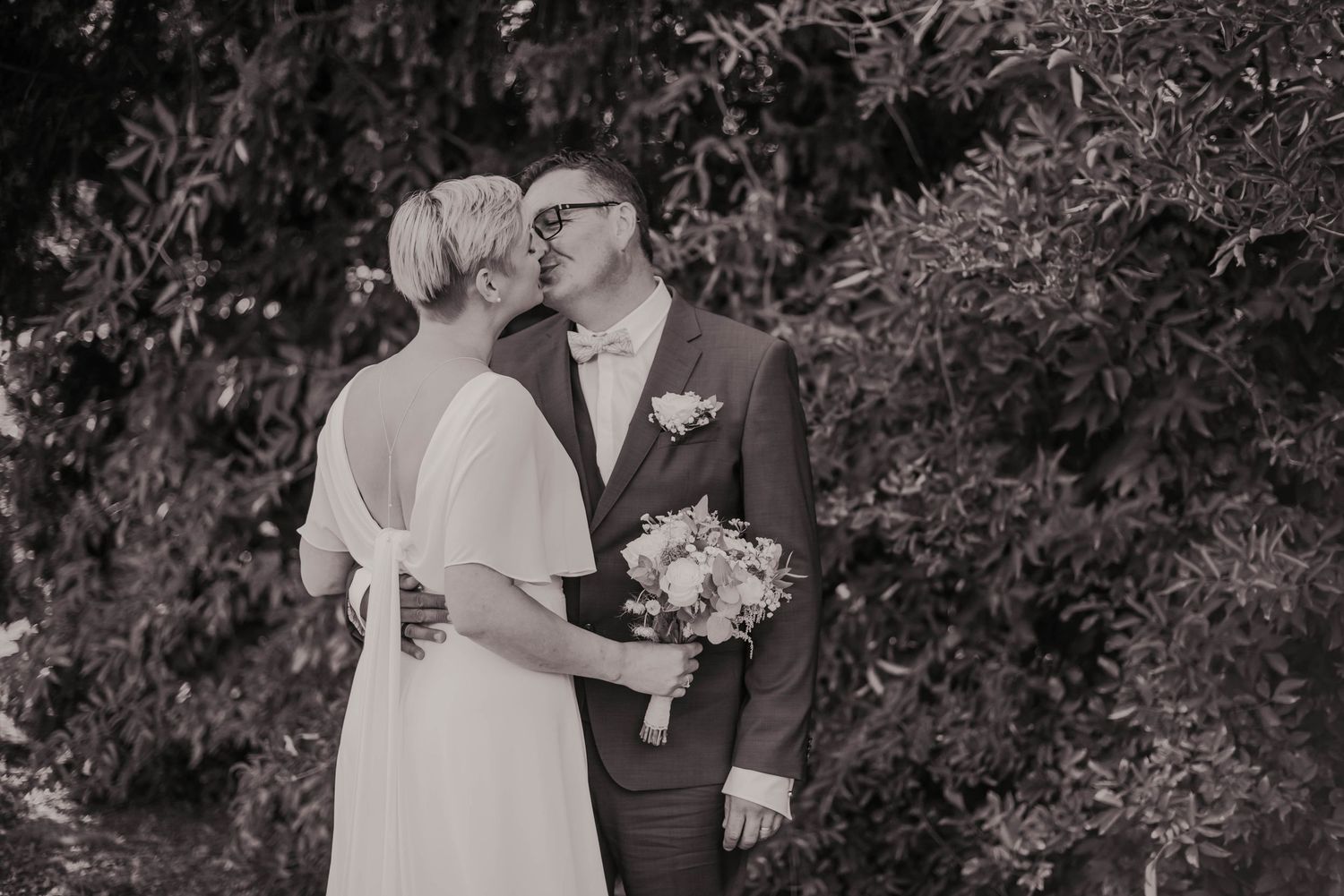 Black and white wedding portraits showing tender moments between the couple.