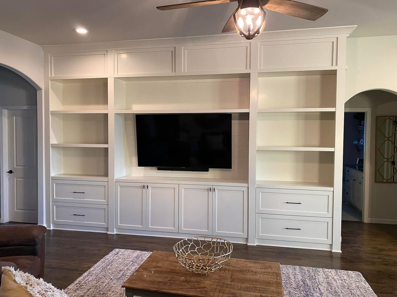 Floor-to-ceiling cabinetry. A mix of open shelving for television, books and décor, paired with closed cabinets and drawers for a tidy look.
