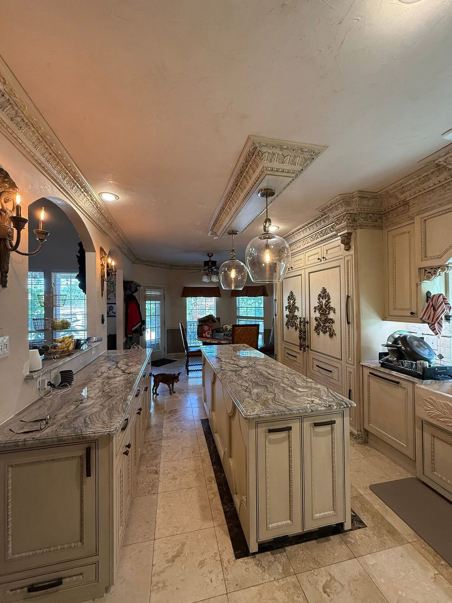 Large island with integrated trash disposal bins, built in storage systems. Custom lighting fixture.