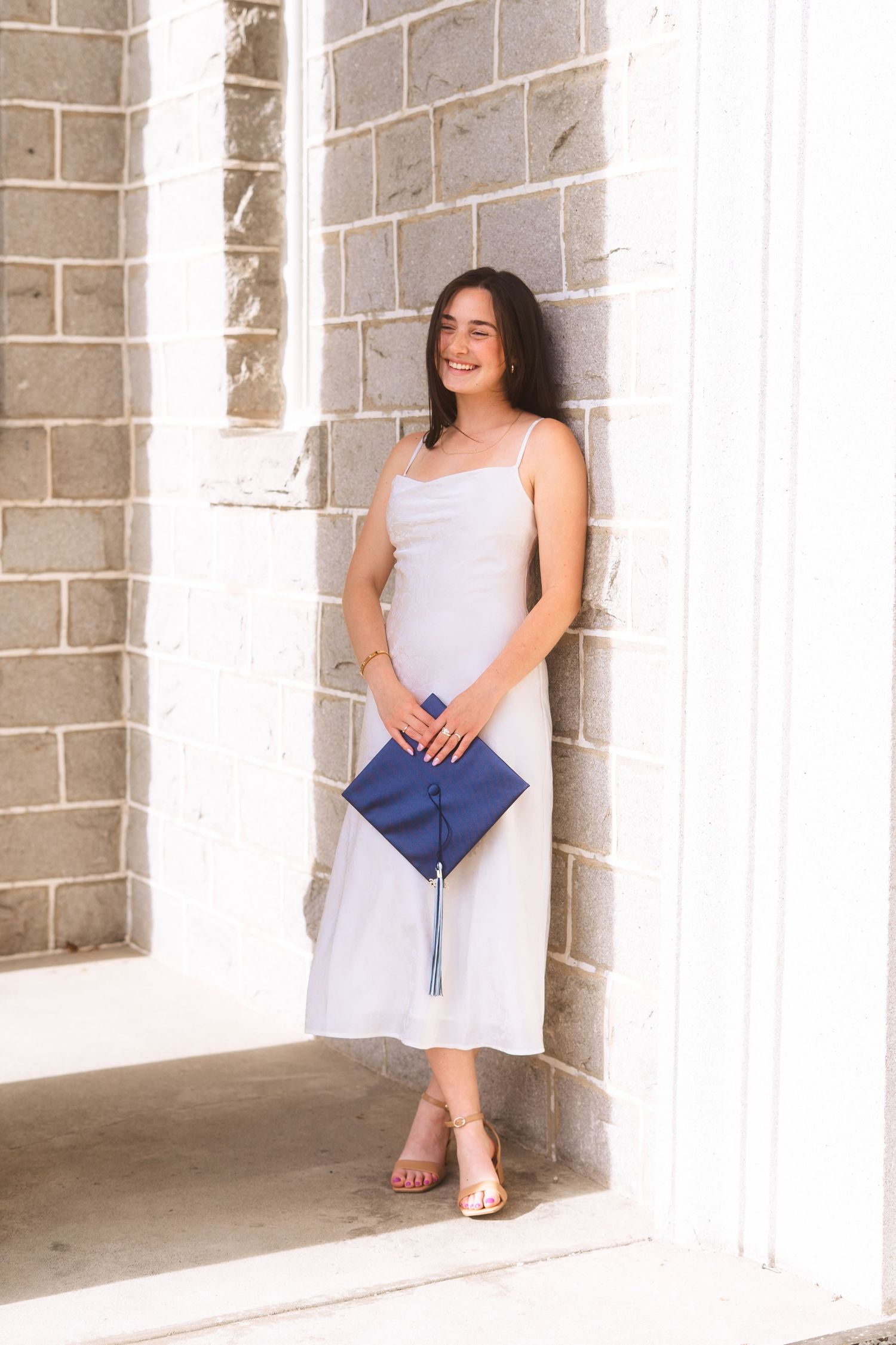girl leaning against wall posing