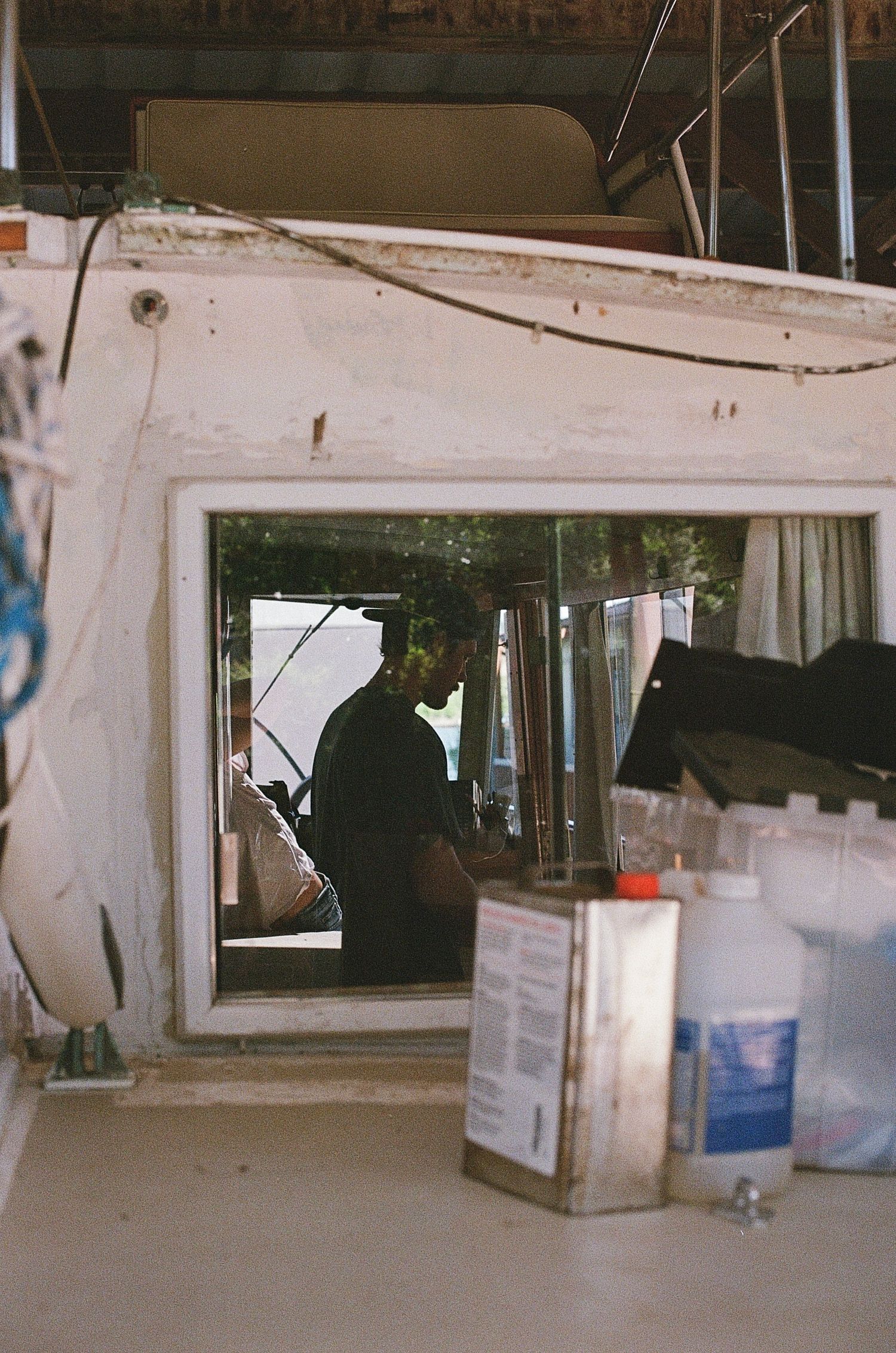 man in boat through window