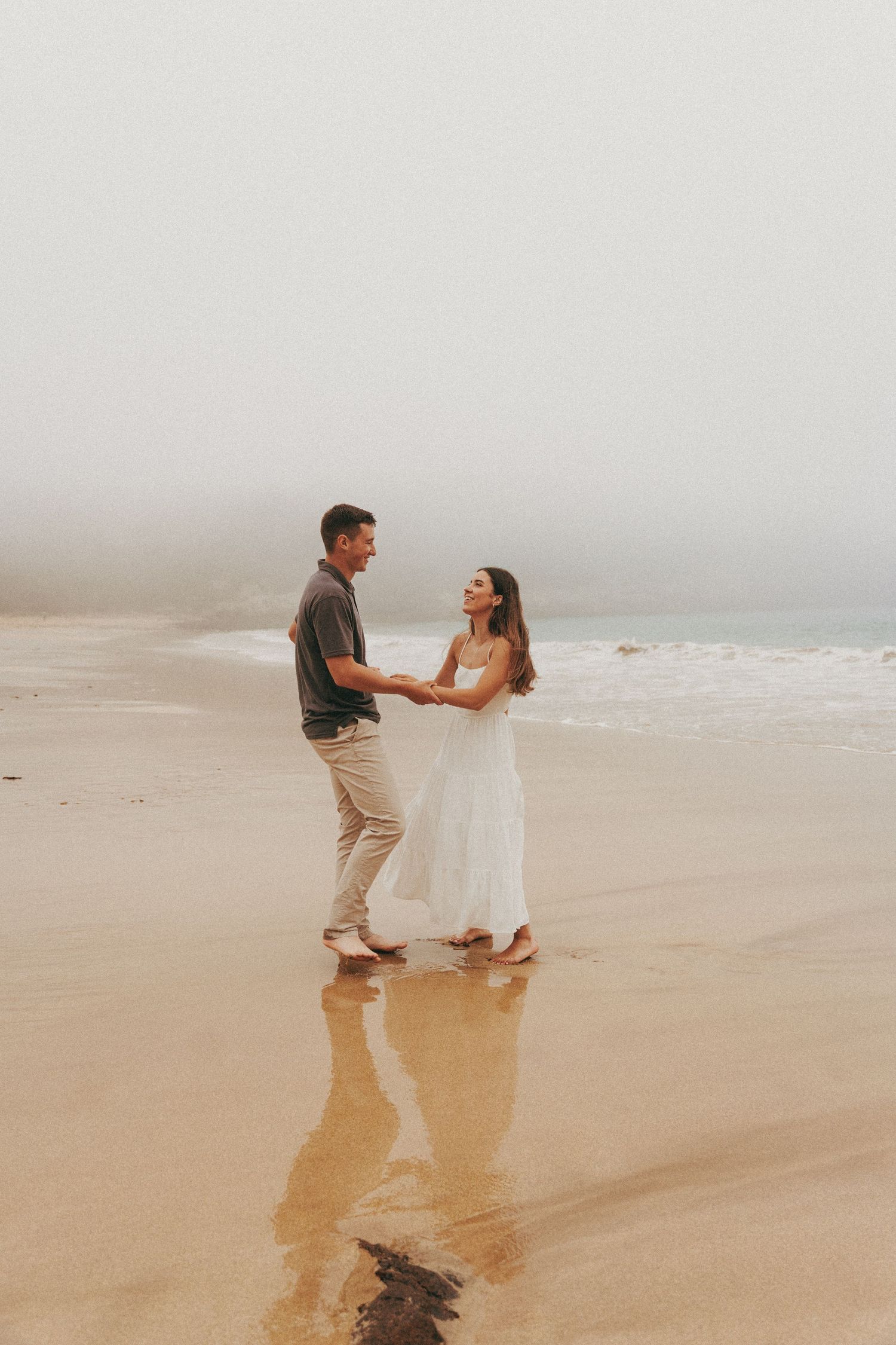 couple holding hands and laughing