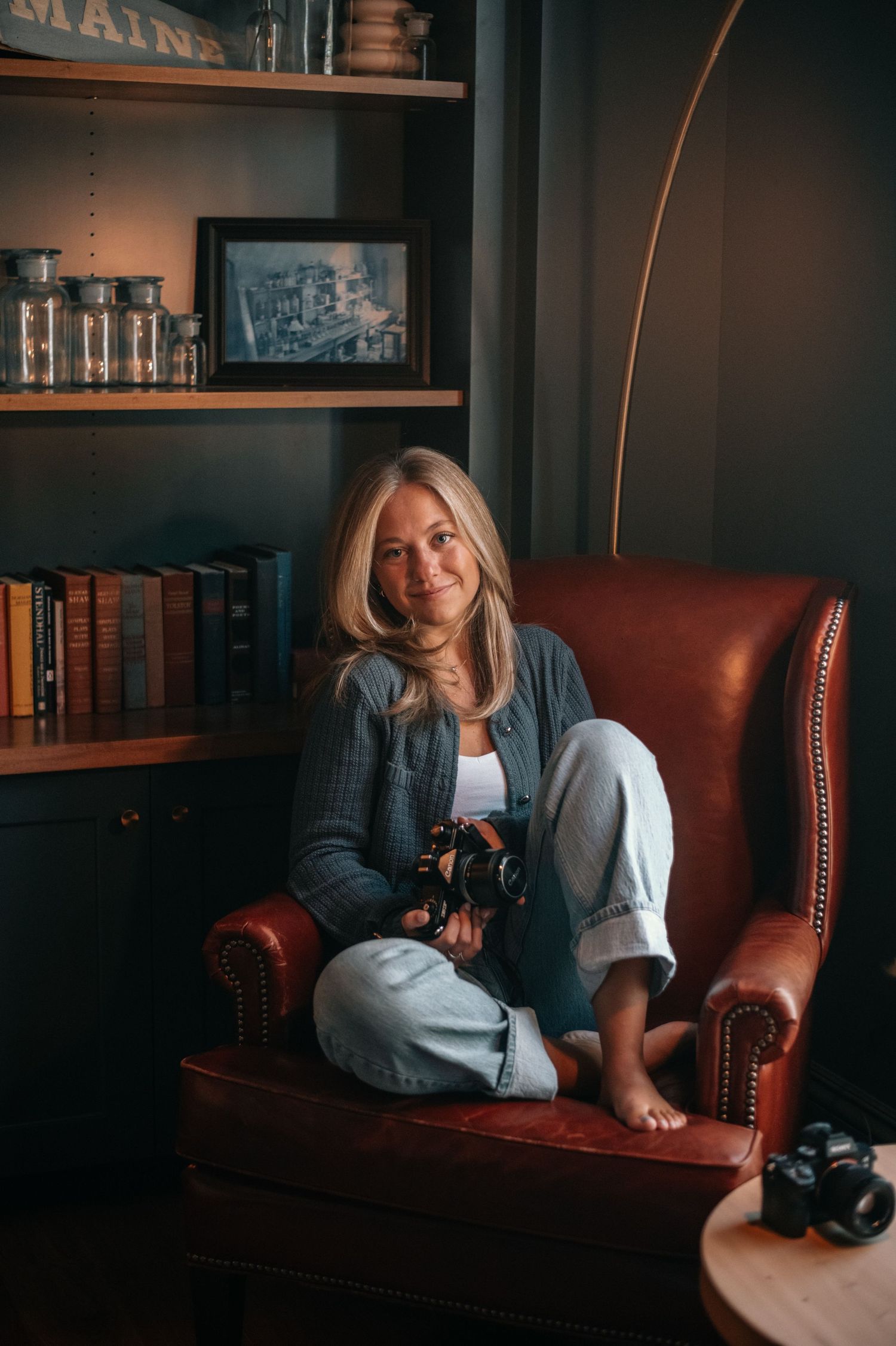 woman sitting in chair holding camera