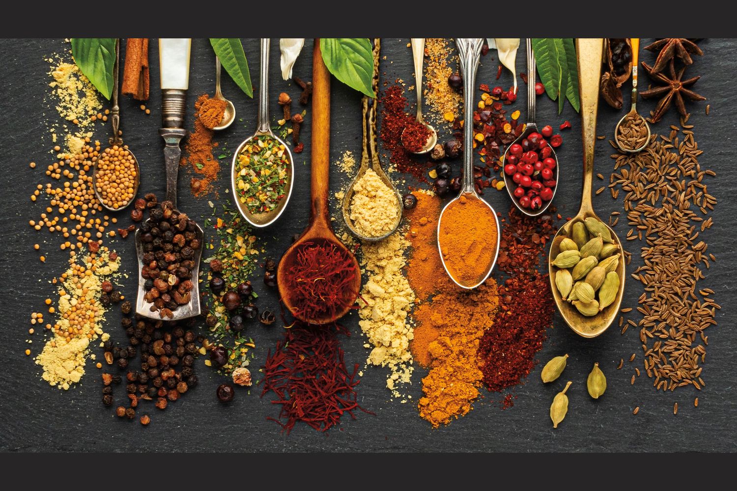 Overhead shot of aromatic spices on tiny spoons