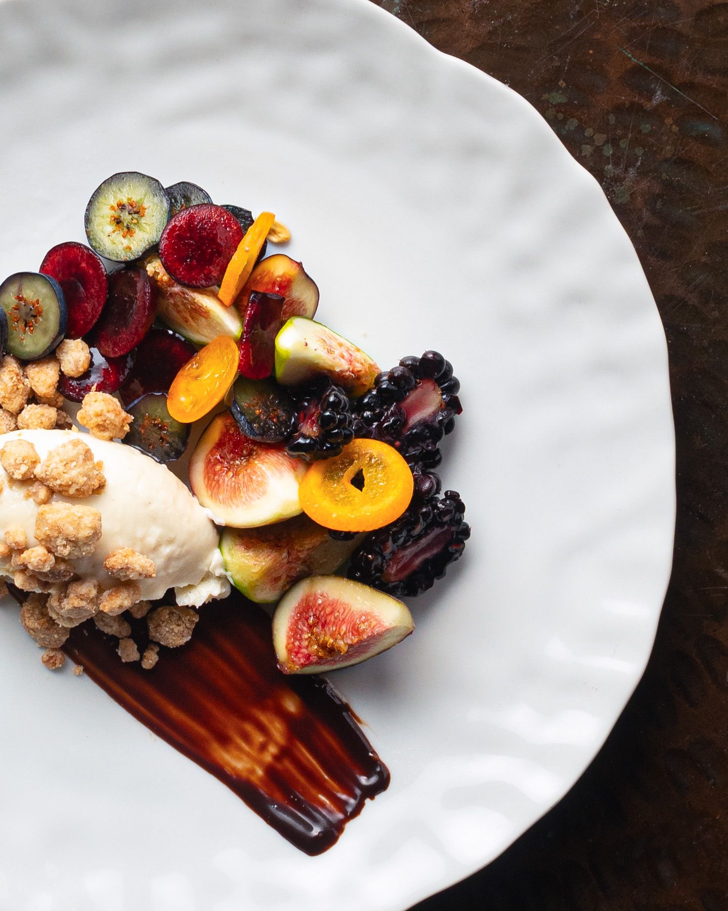 Overhead image of figs and berries with ice cream and chocolate sauce prepared by a Philadelphia chef