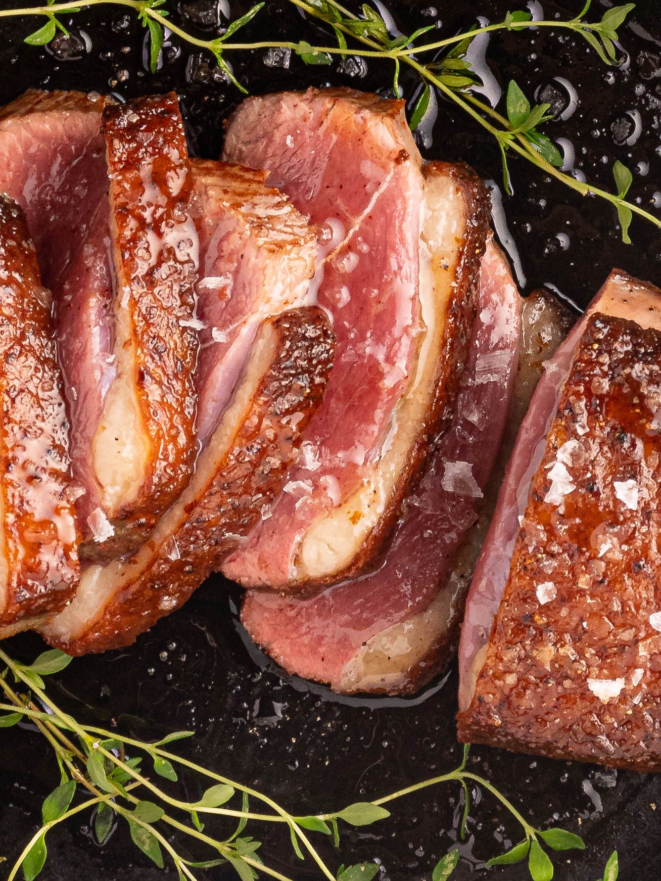 Close-up overhead shot of perfectly cooked medium-rare duck breast