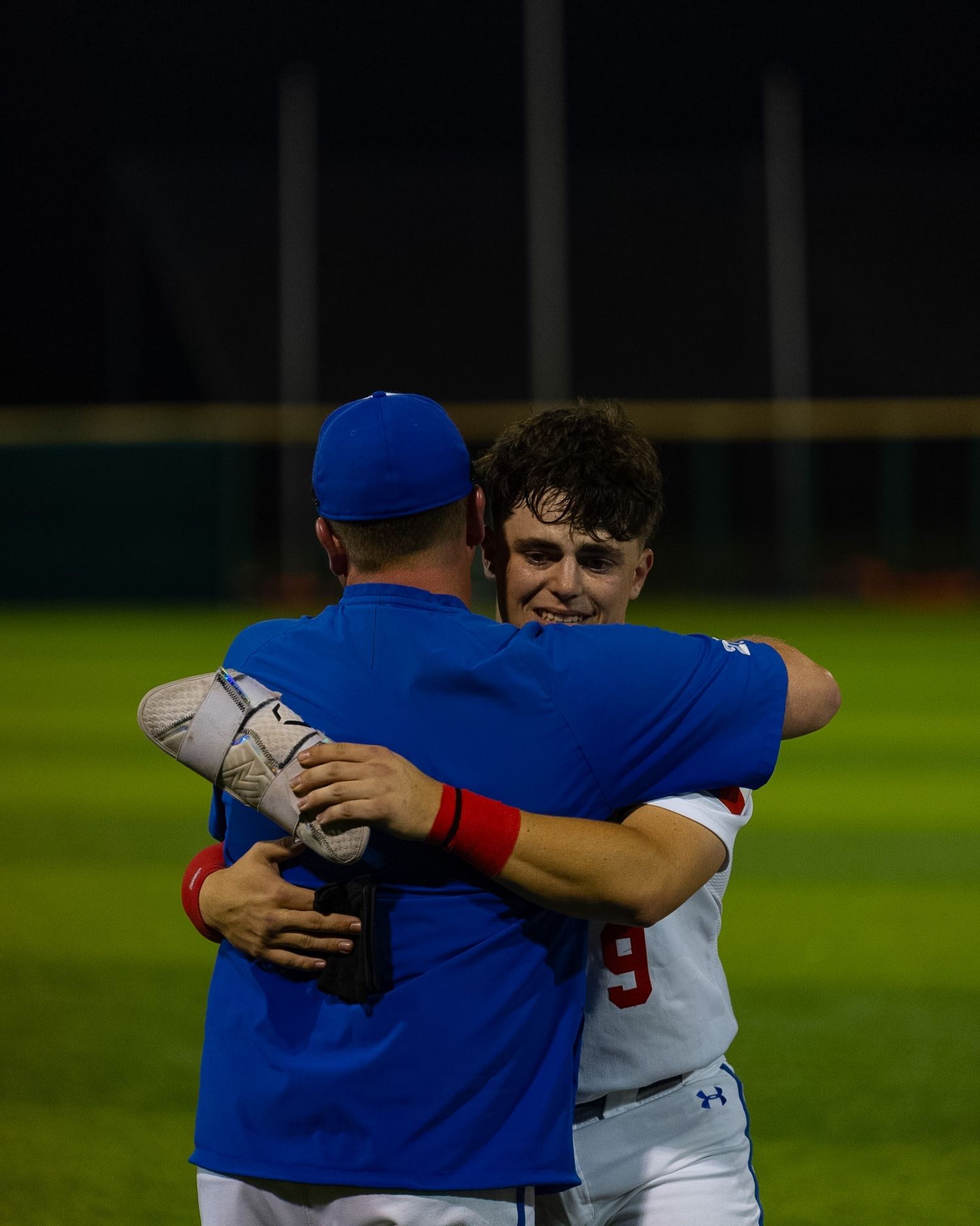 baseball player emotionally hugging coach