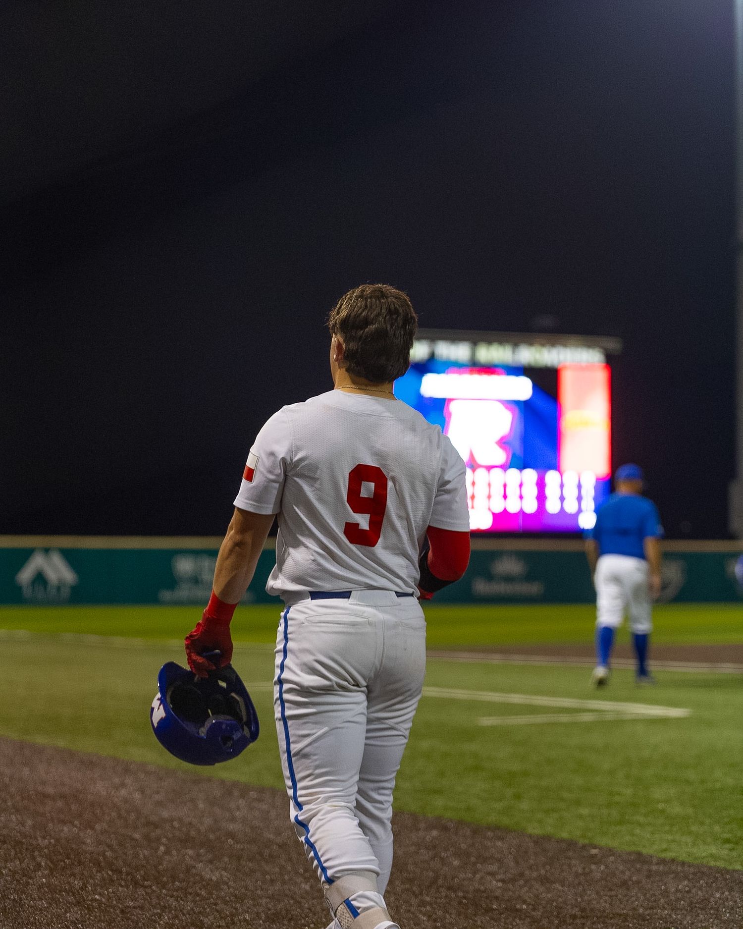 baseball player walking back to the dugout