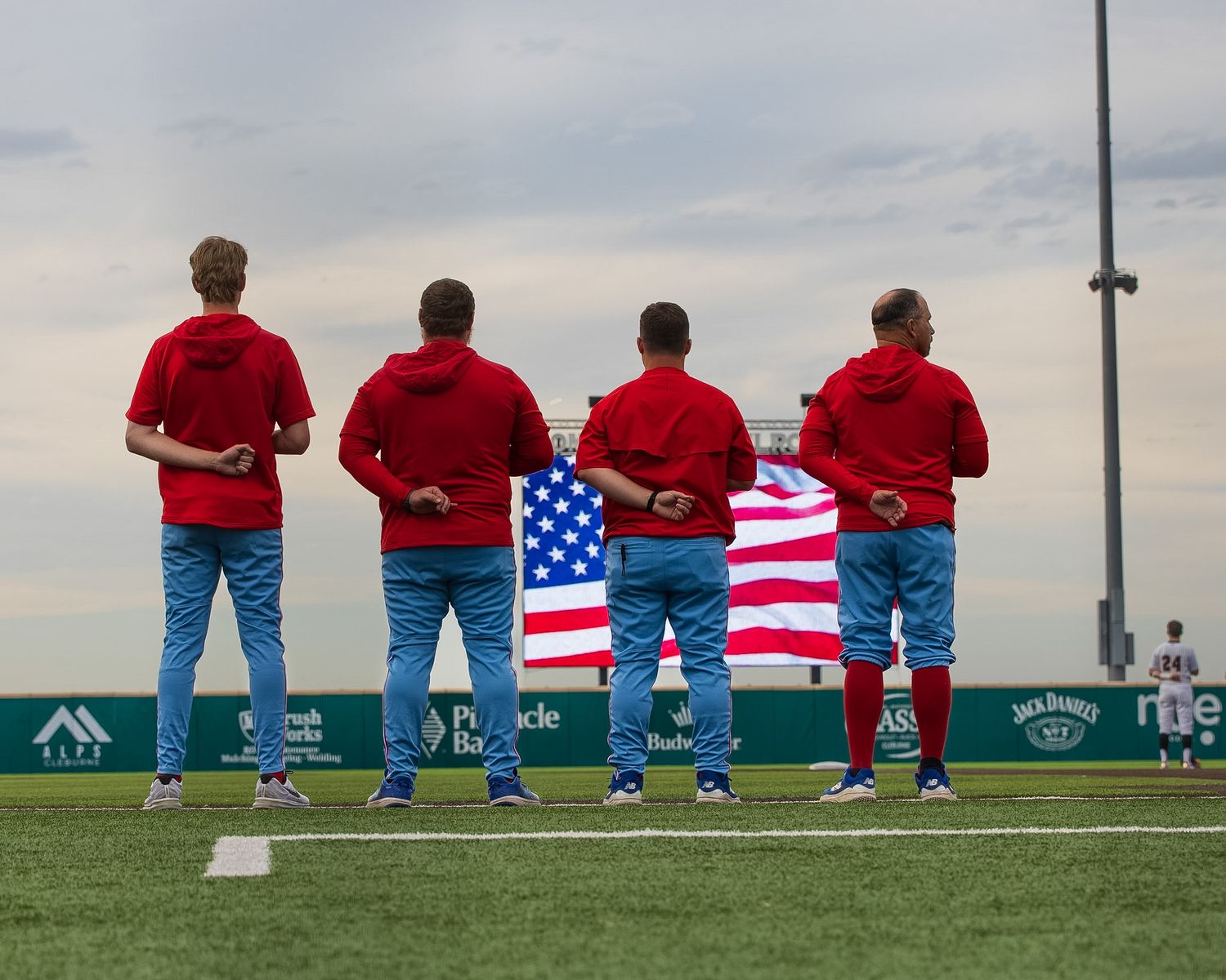 four coaches standing for the National Anthem