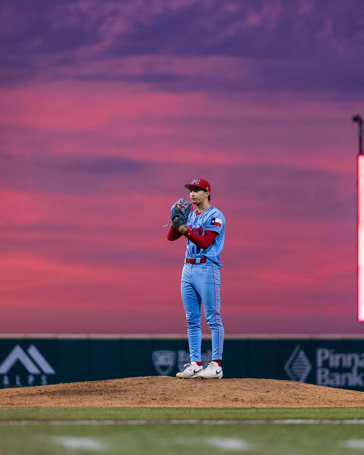 pitcher on the mound getting ready to pitch