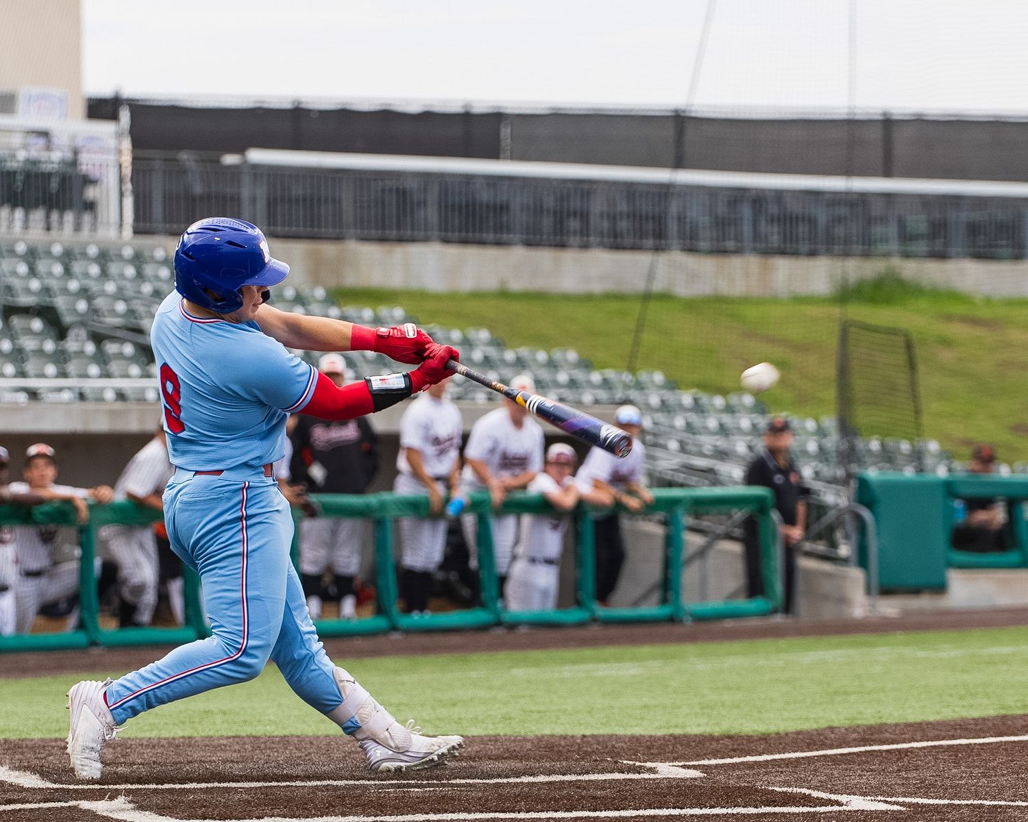 baseball player swinging at the baseball