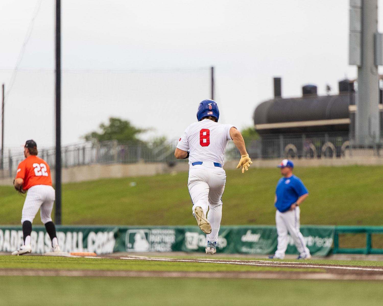 baseball player running towards first base