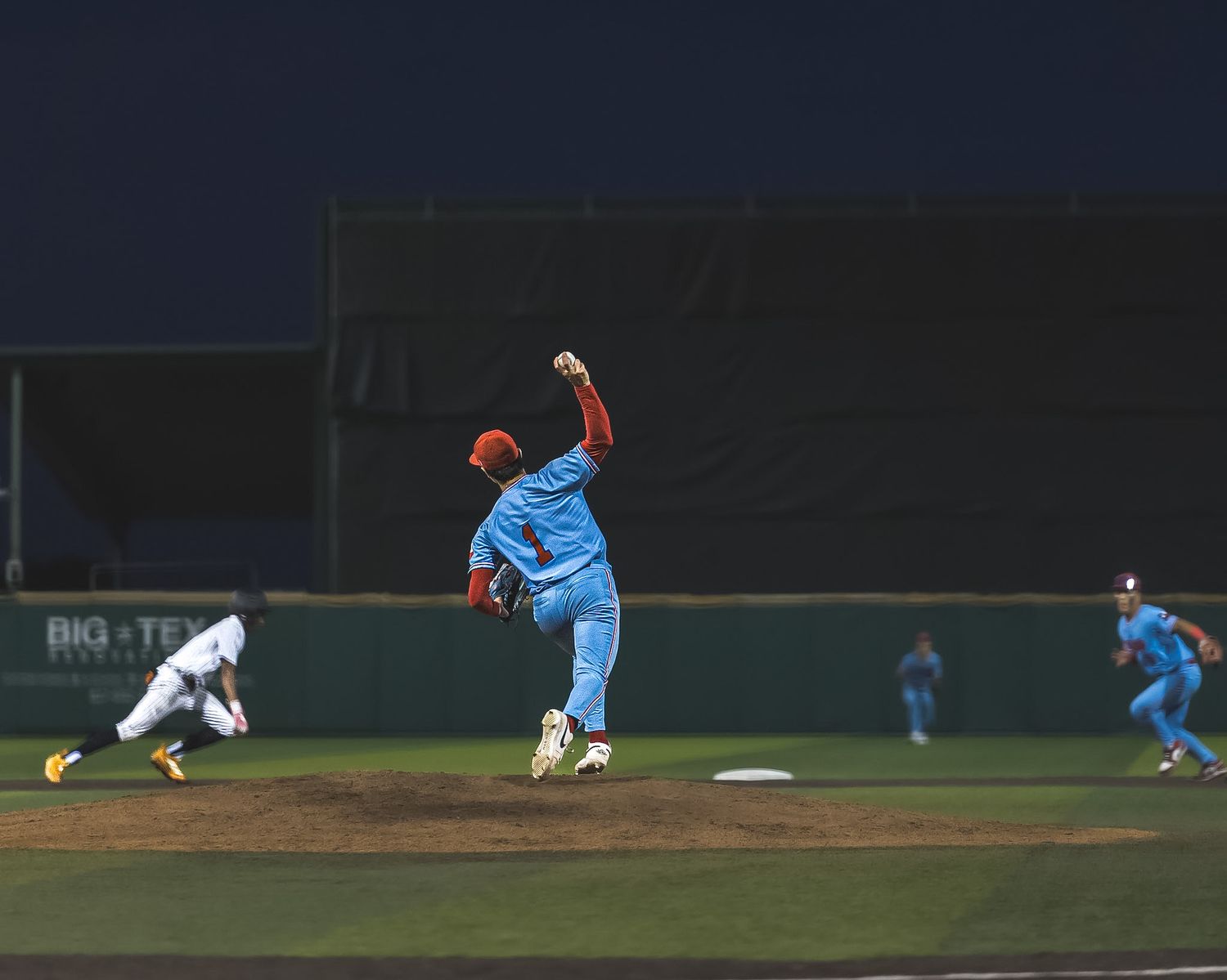 pitcher throwing the ball towards second base