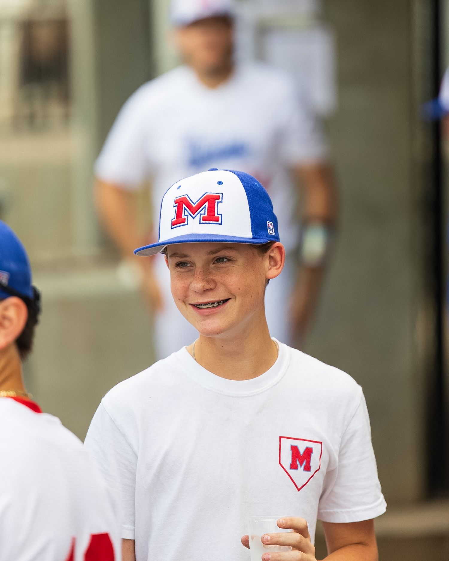 boy in baseball cap smiling