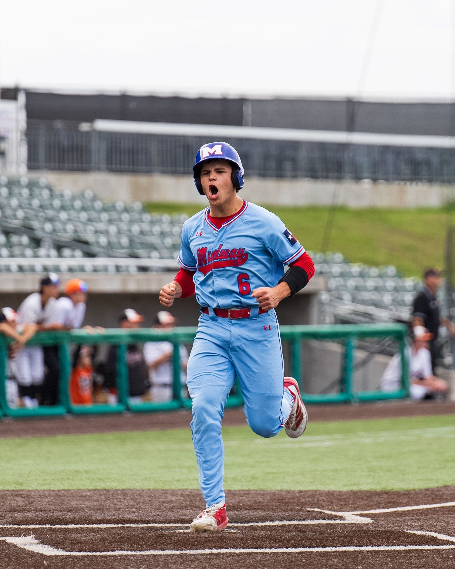 baseball player scoring at home plate