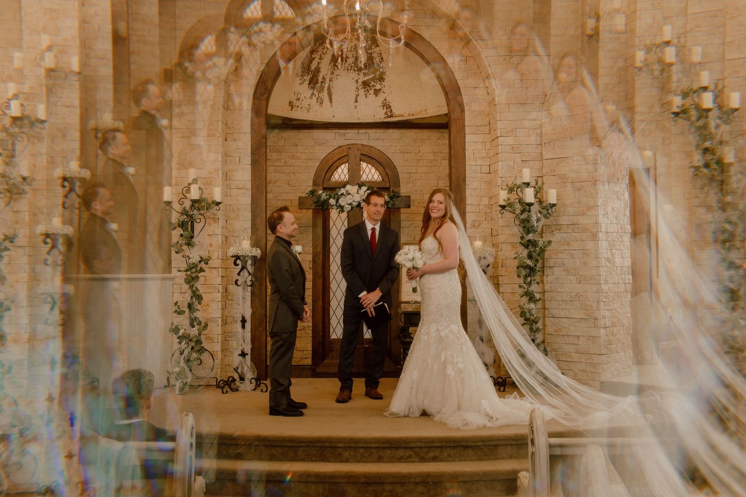 Bride and groom stand at the altar of an elegant chapel during wedding ceremony.
