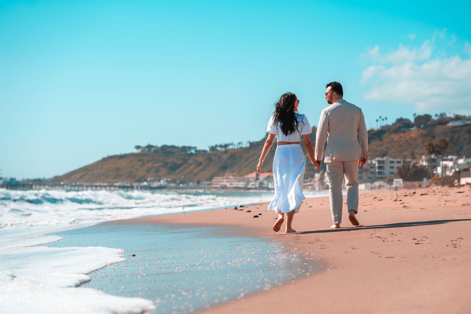 Scenic coastal beach panorama showing multiple views of waves crashing on sandy shoreline with people walking along water's edge.