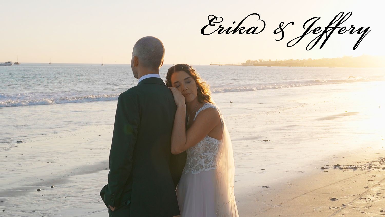 A sunset beach wedding photo of a couple embracing on the shoreline.