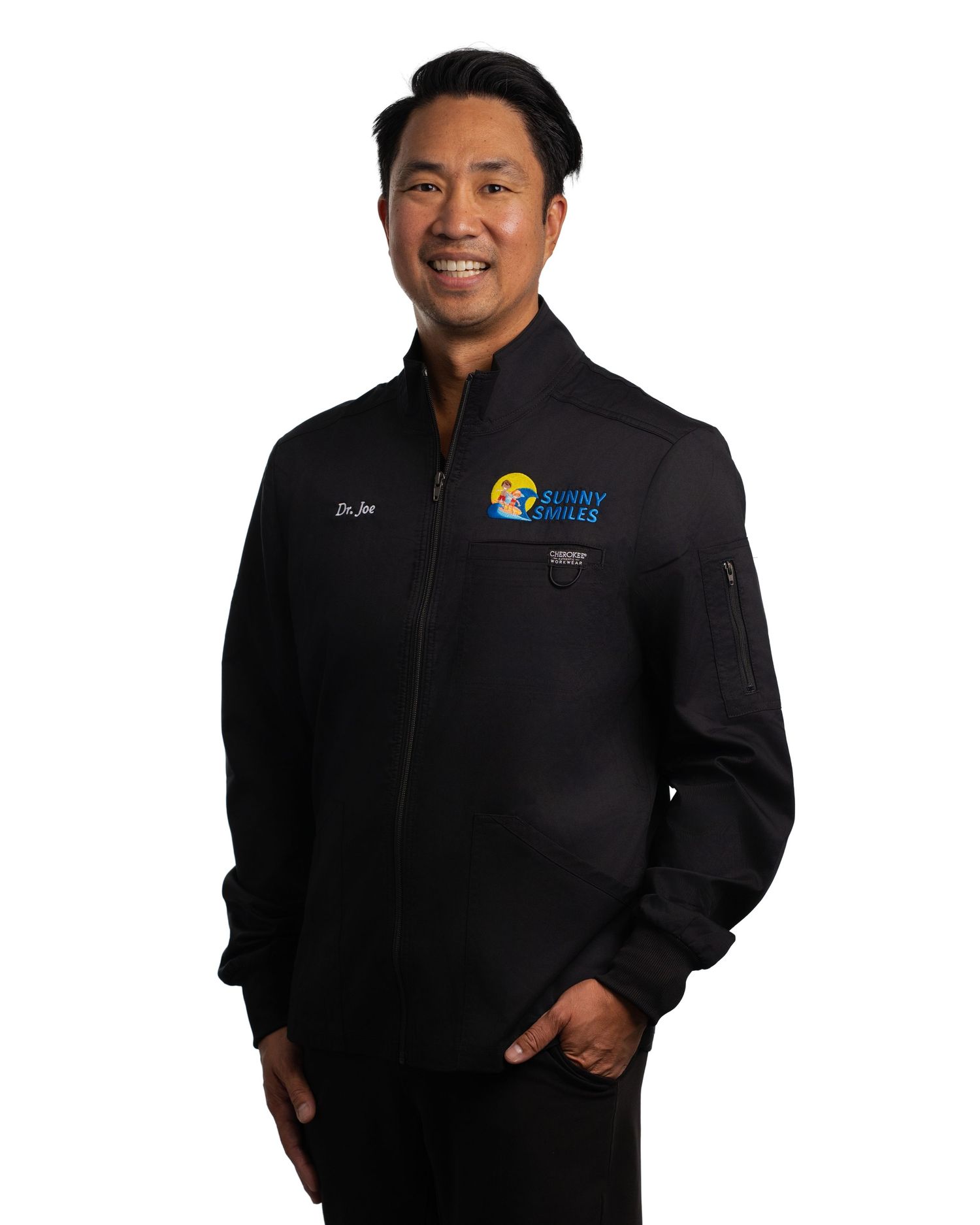 Man wearing black full-zip jacket with Sunny Smiles logo, standing confidently against white background.