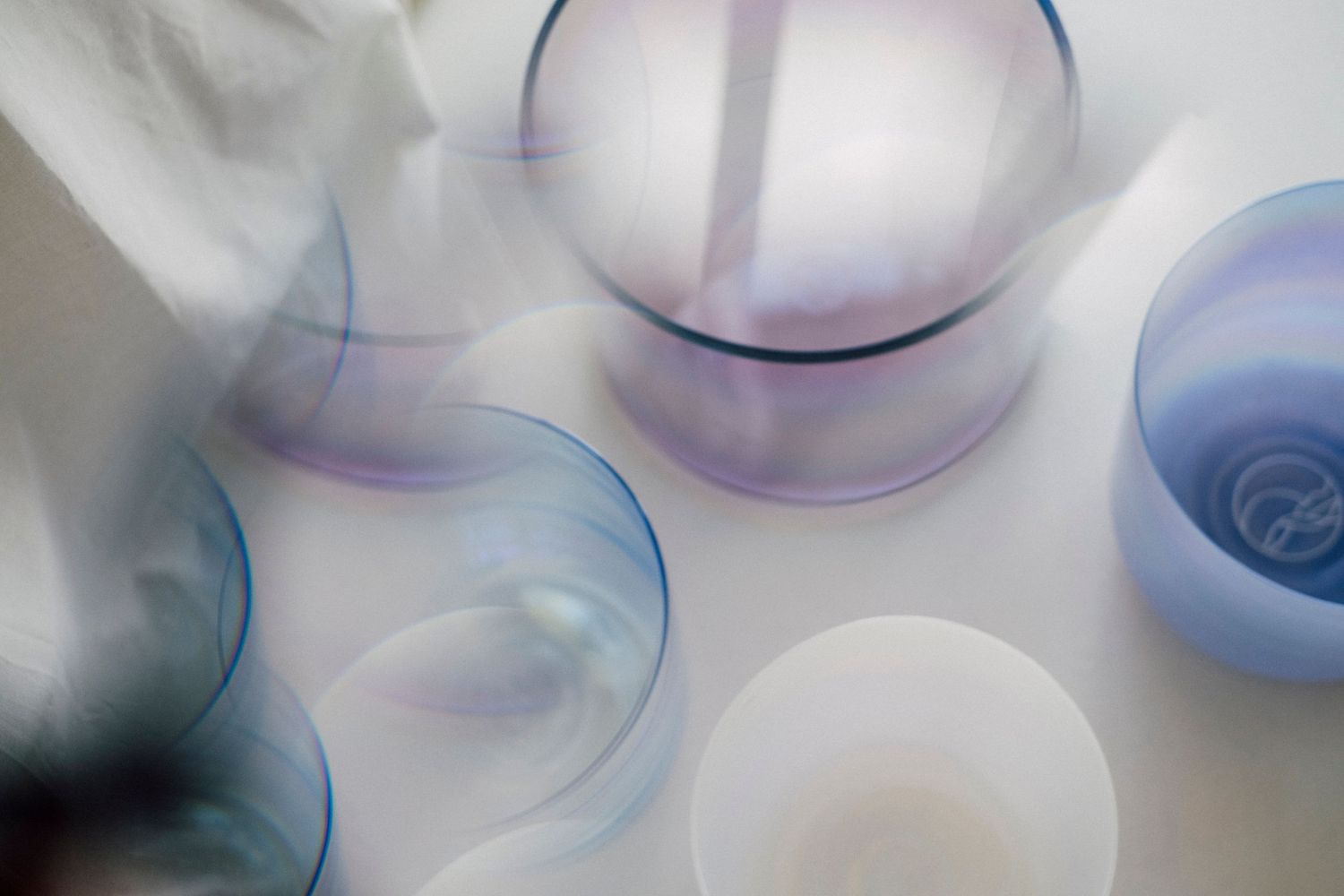 Abstract circular shapes in soft blue and white tones creating an ethereal composition.
