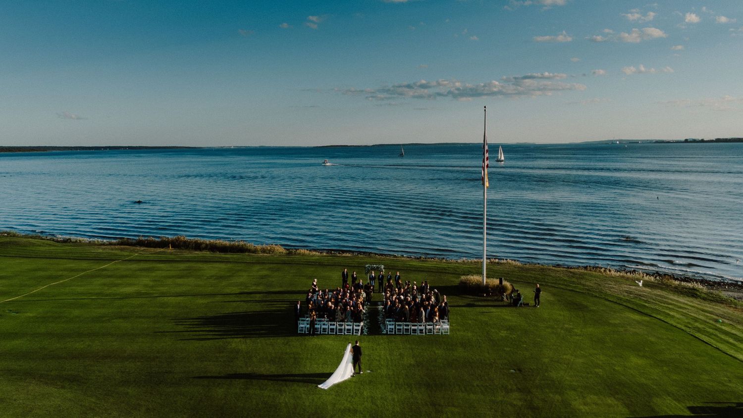 Memory Lane Studios drone wedding videography in Boston showcasing coastal ceremony venues with ocean views and waterfront setups