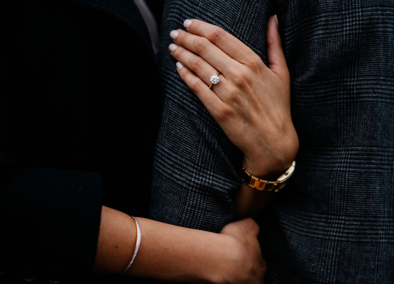 Memory Lane Studios fine art wedding detail photography at Brooklyn Bridge New York featuring engagement ring and couple holding hands