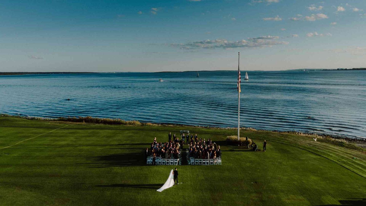 Memory Lane Studios Connecticut Country Club wedding ceremony photography featuring scenic ocean views and waterfront celebration by Tharun