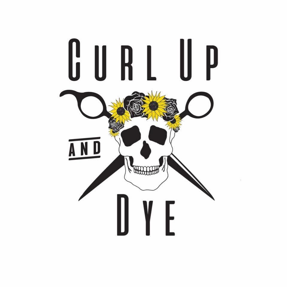 Curl Up and Dye salon logo featuring a skull with sunflowers and crossed scissors in black and yellow.