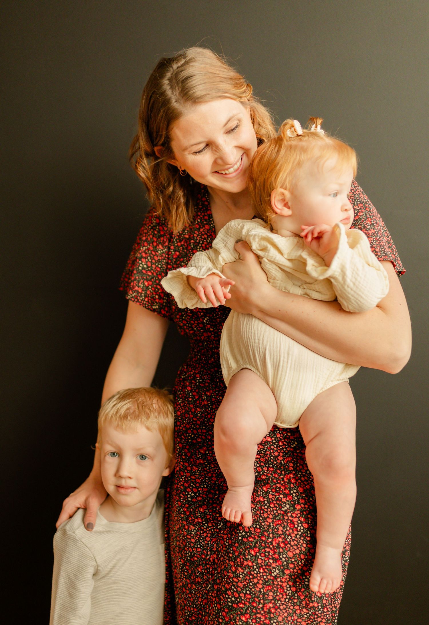A warm family portrait showing tender moments between parent and children.