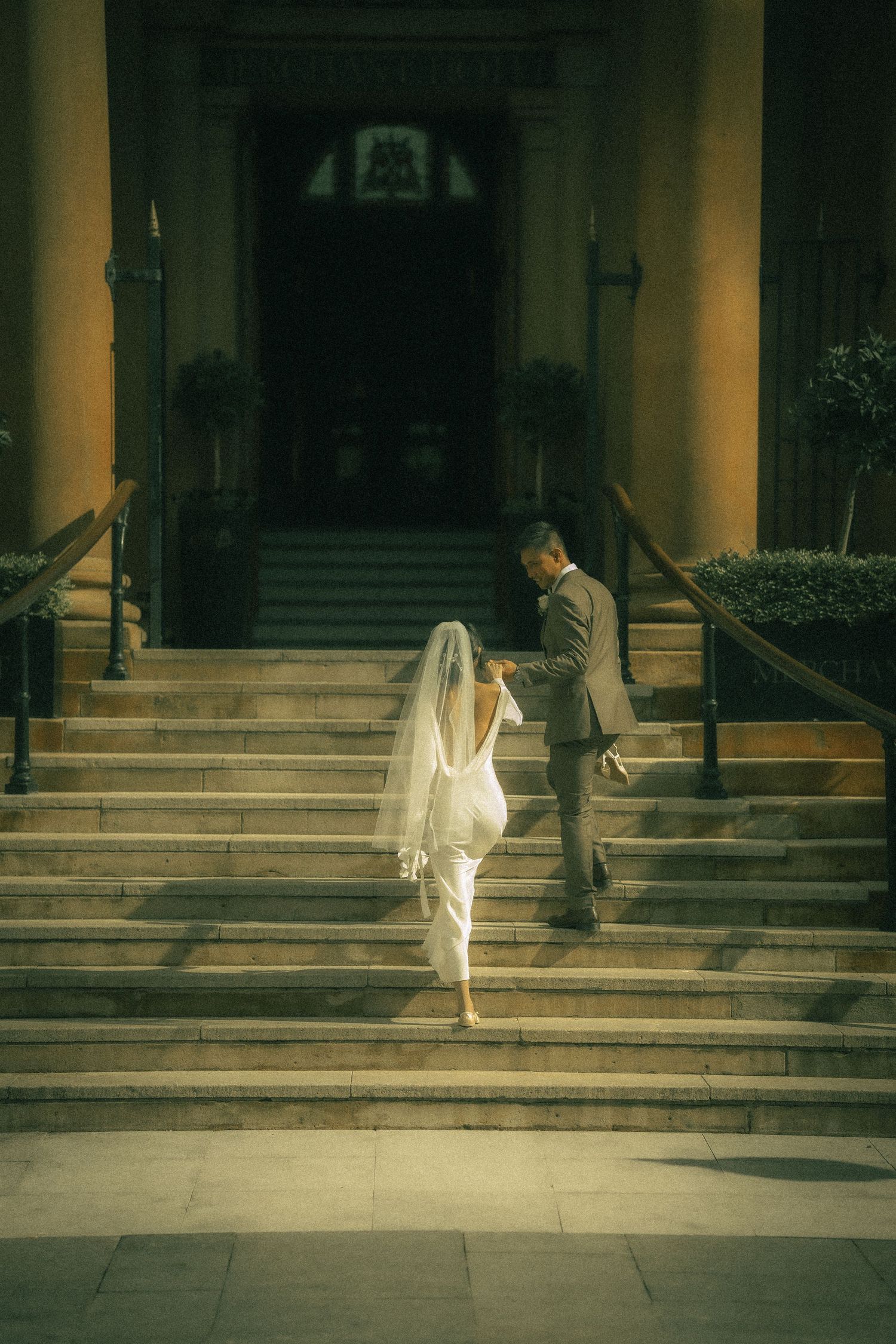Romantic newlywed portrait in soft evening light.