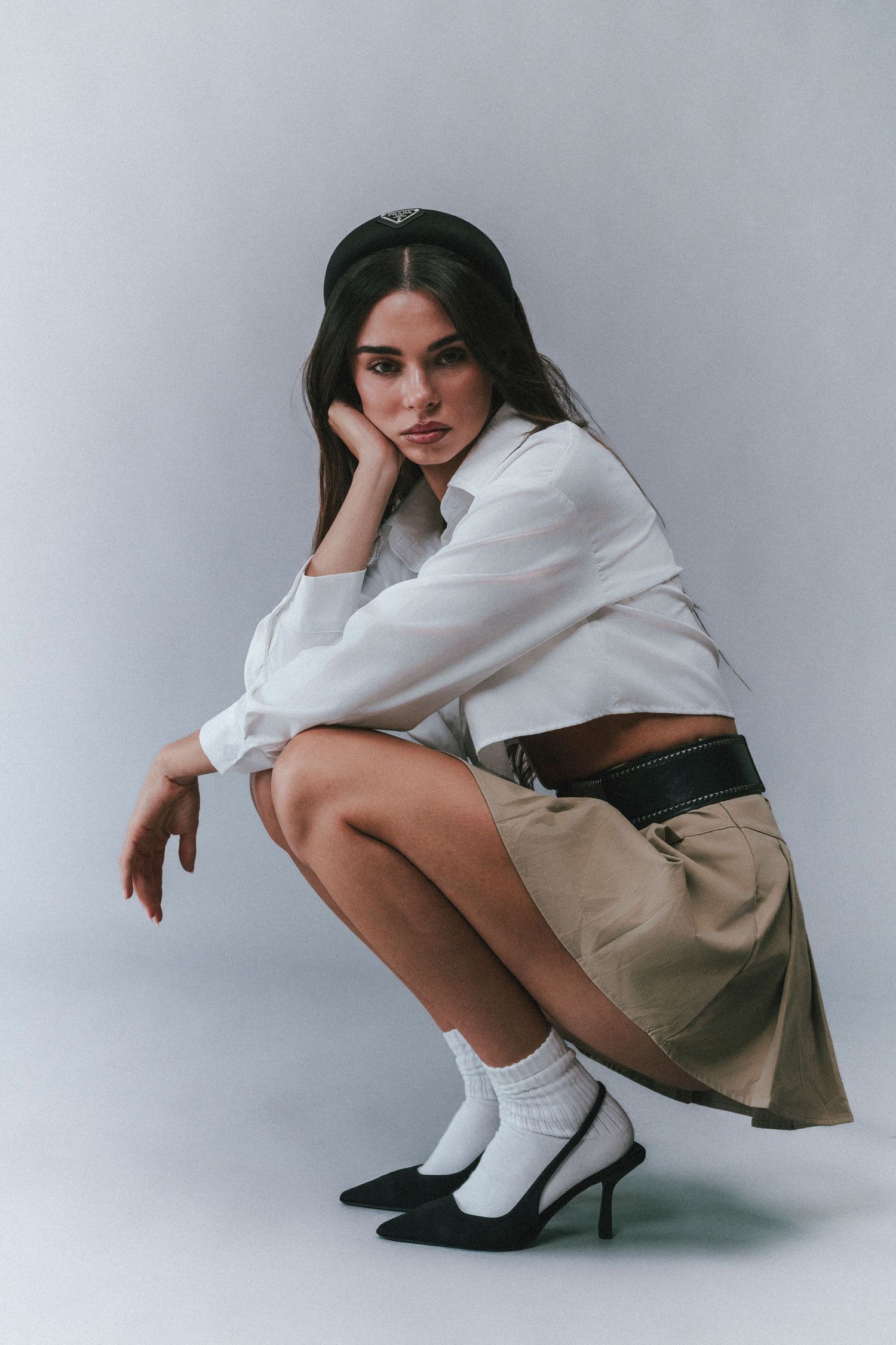 Preppy-style fashion portrait photographed in a bright, polished setting with classic preppy clothing and timeless styling.