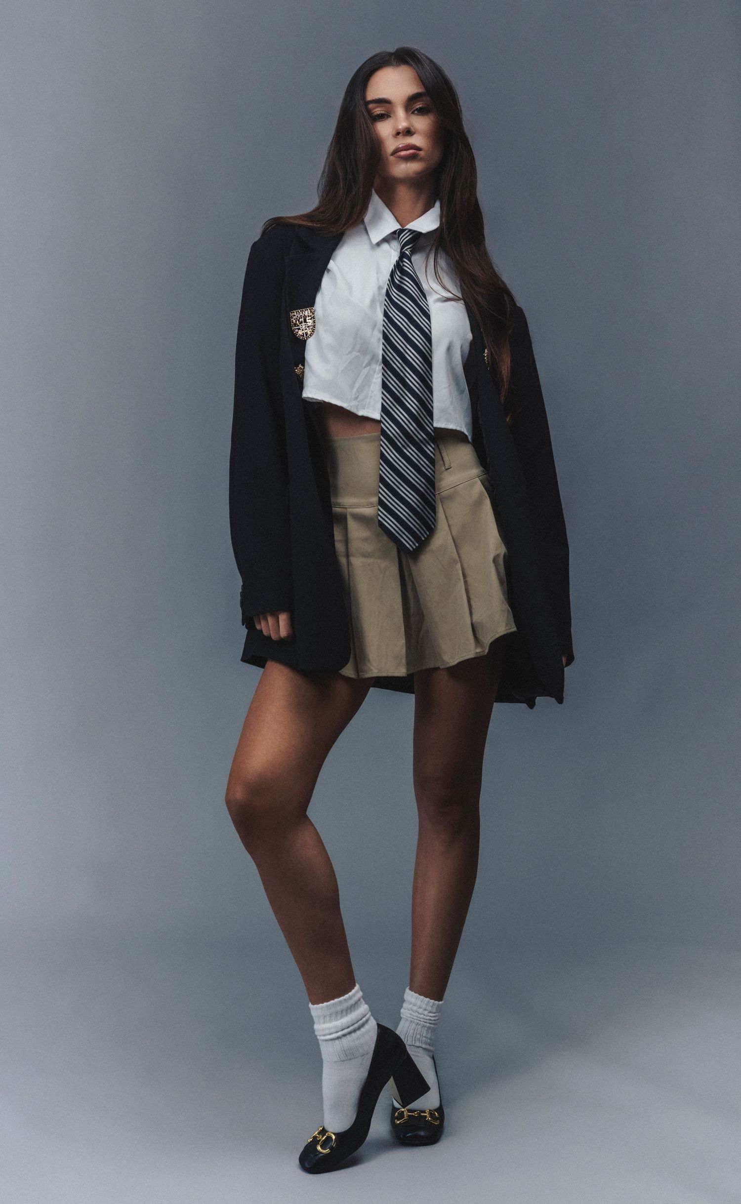 Preppy-style fashion portrait photographed in a bright, polished setting with classic preppy clothing and timeless styling.